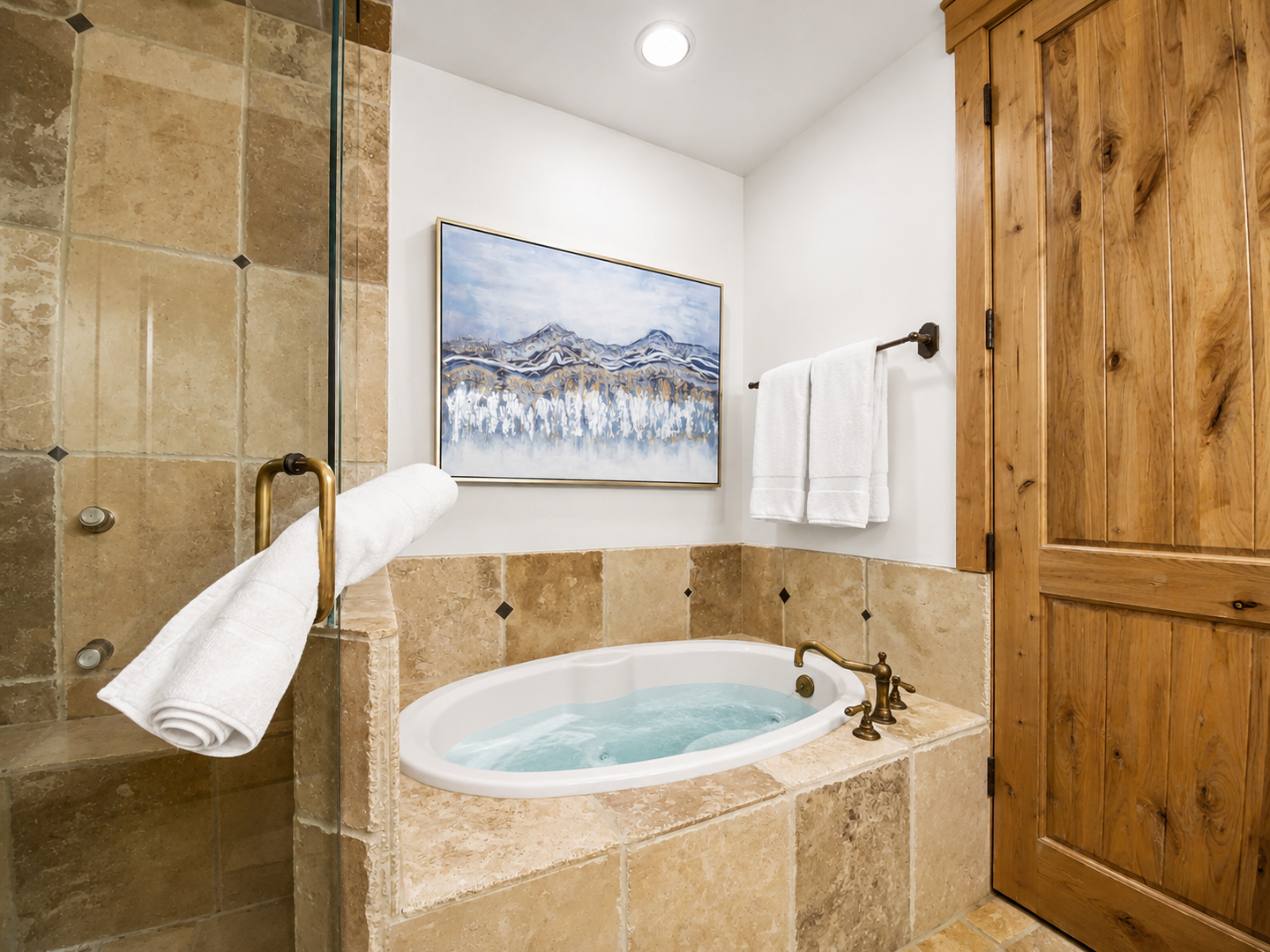 Your spa-like Primary Ensuite bathroom features a luxurious walk-in shower with elegant stone tiles and a beautiful copper basin sink for ultimate relaxation. Unit A