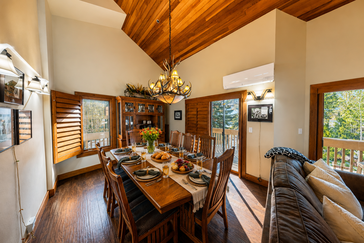 Gather around your spacious dining table beneath soaring wood ceilings, where natural light pours through large windows framing peaceful forest views, inviting memorable meals together.