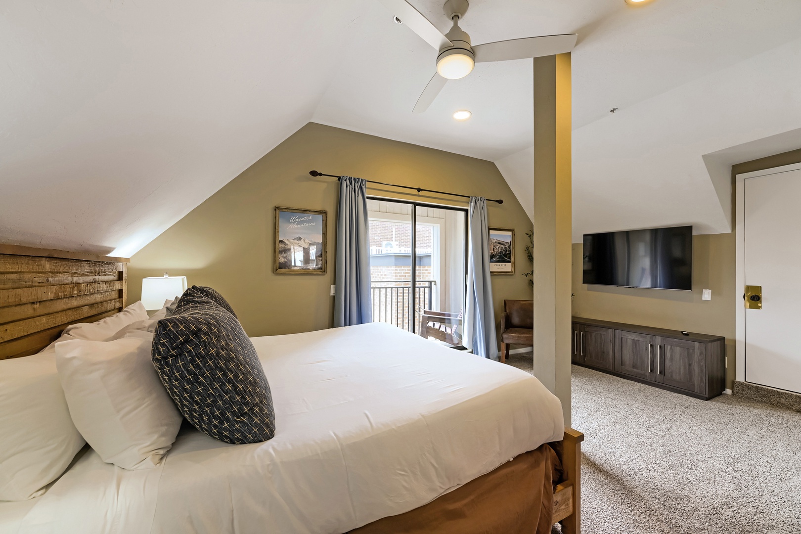 Unwind in your private retreat under vaulted ceilings with a ceiling fan keeping things comfortable. A plush bed invites restful sleep, while the spacious layout and natural light create an airy, serene escape just for you.