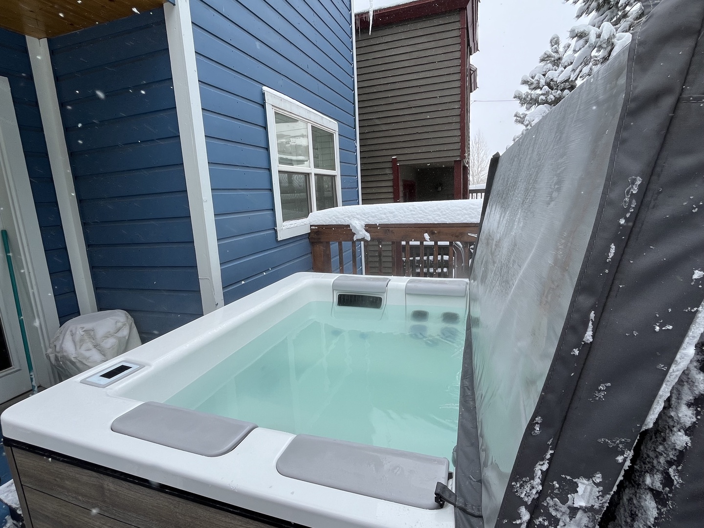 Unwind in this serene winter oasis featuring a private, steaming hot tub on a snowy deck. Perfect for après-ski relaxation, this cozy retreat offers the ultimate seasonal escape.