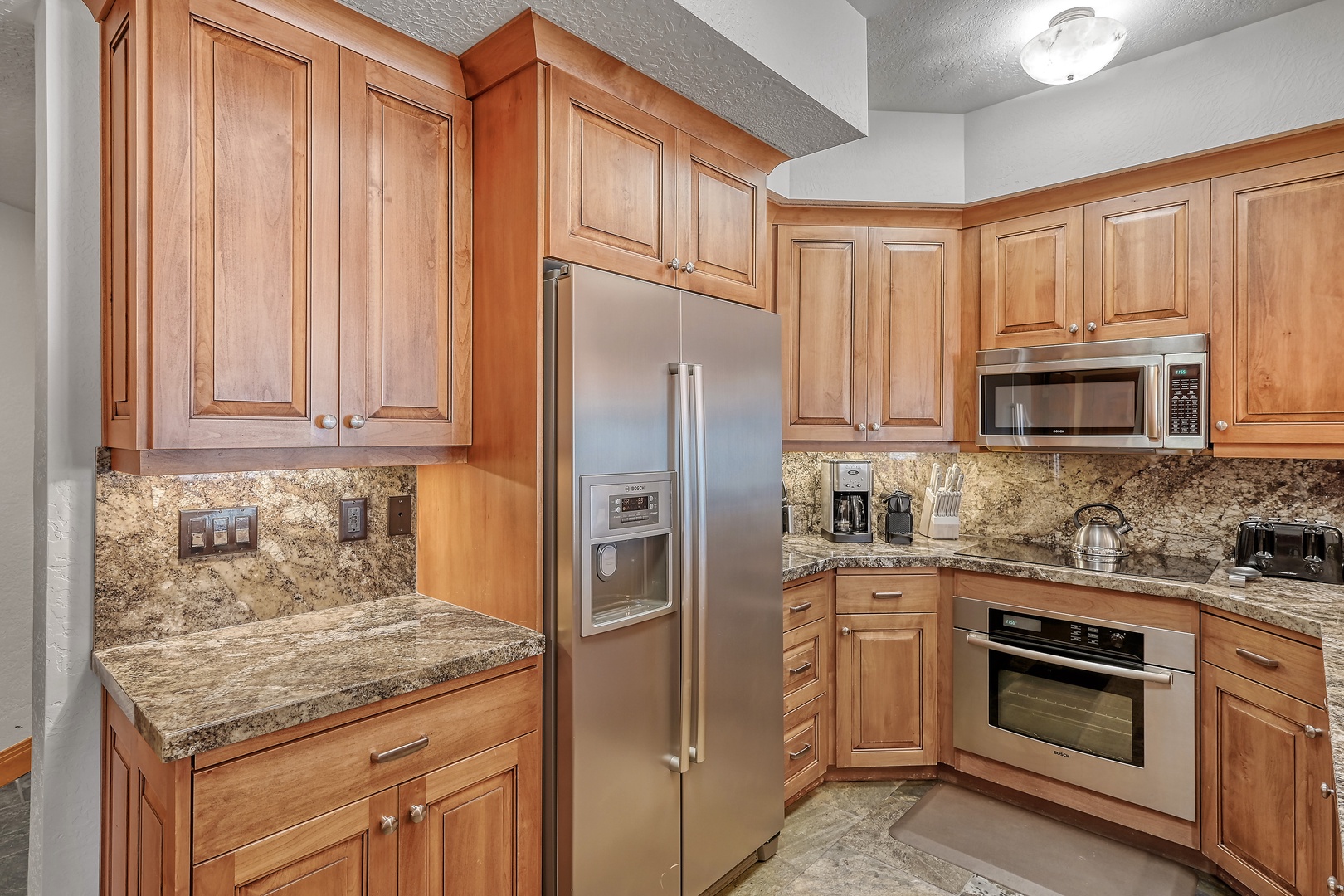 Your fully-equipped kitchen welcomes you with warm wood cabinetry, granite counters, and stainless steel appliances for memorable meal preparations.