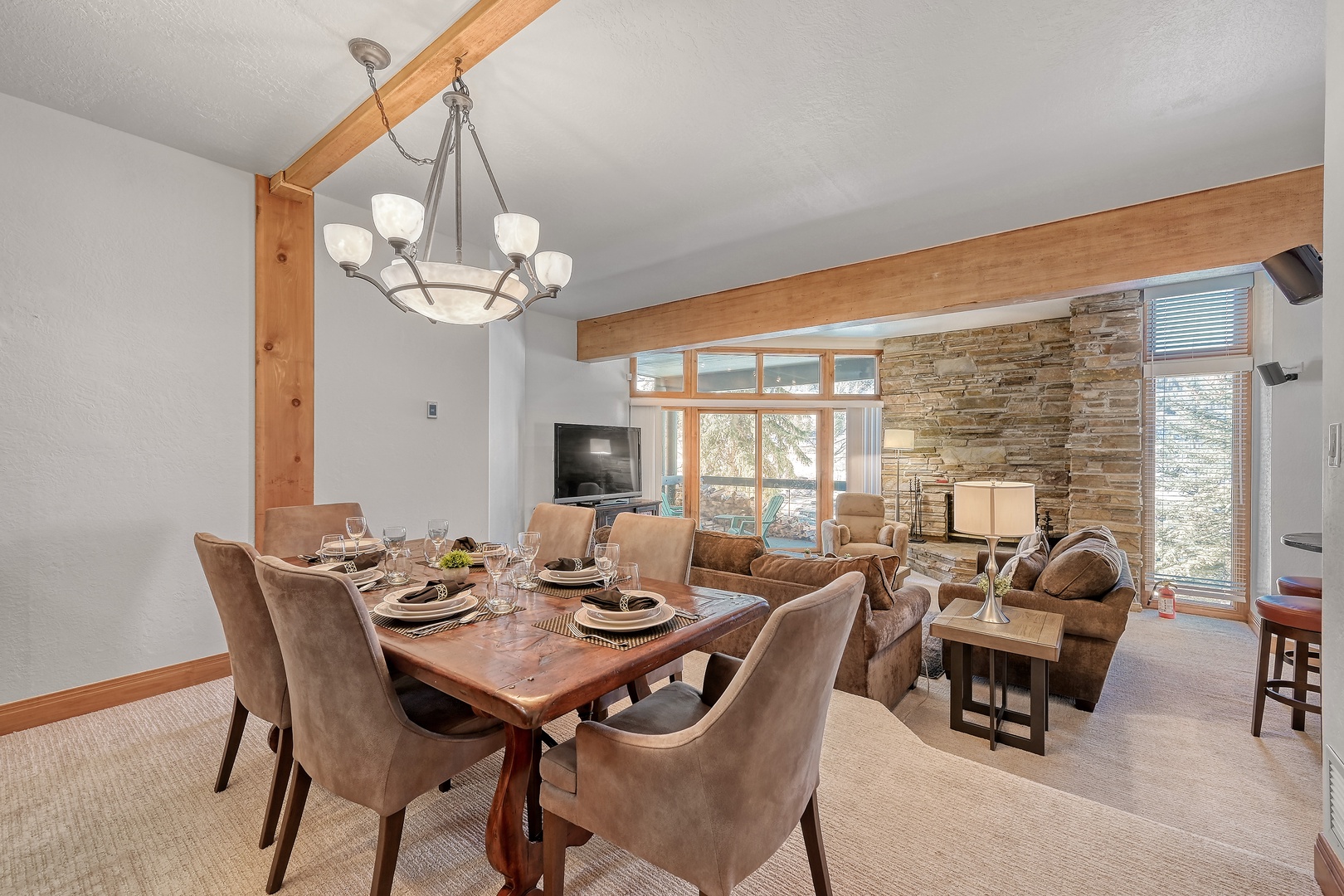 You'll love gathering around this elegant dining table with mountain views streaming through large windows, perfect for memorable meals together.