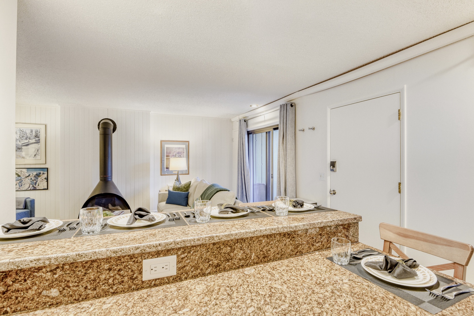 Your stylish granite breakfast bar creates the perfect spot for morning coffee and casual dining in your bright, modern space.