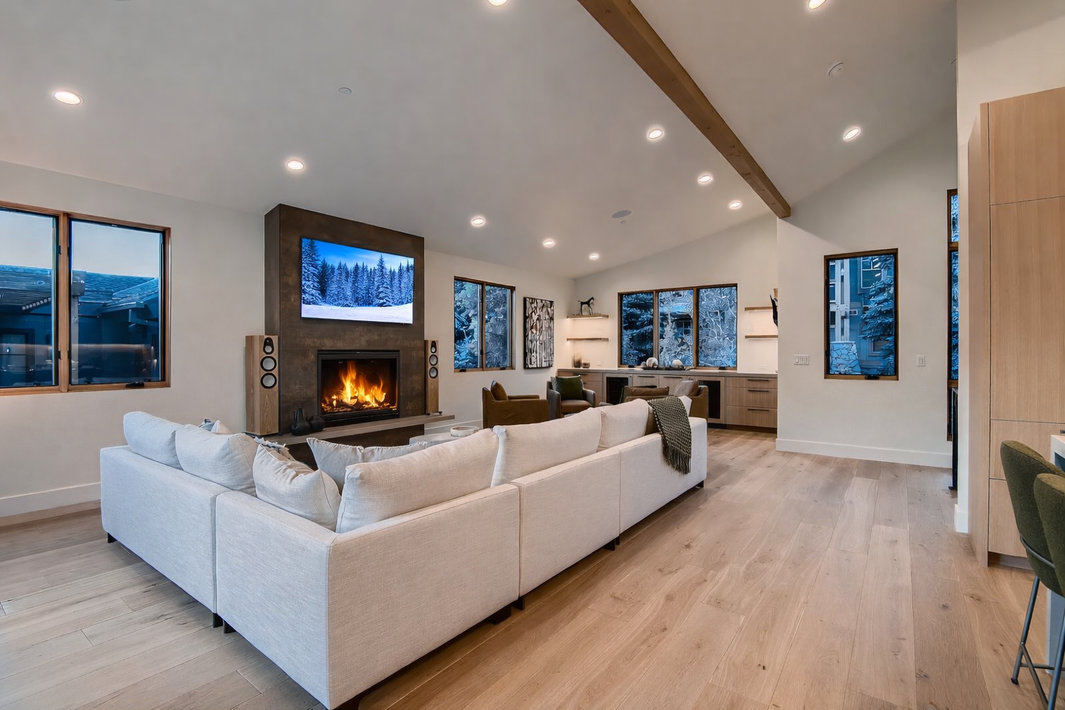 Gather in the stunning, vaulted living room with a cozy stone fireplace and large smart TV. The perfect spot to relax after a day exploring Park City.