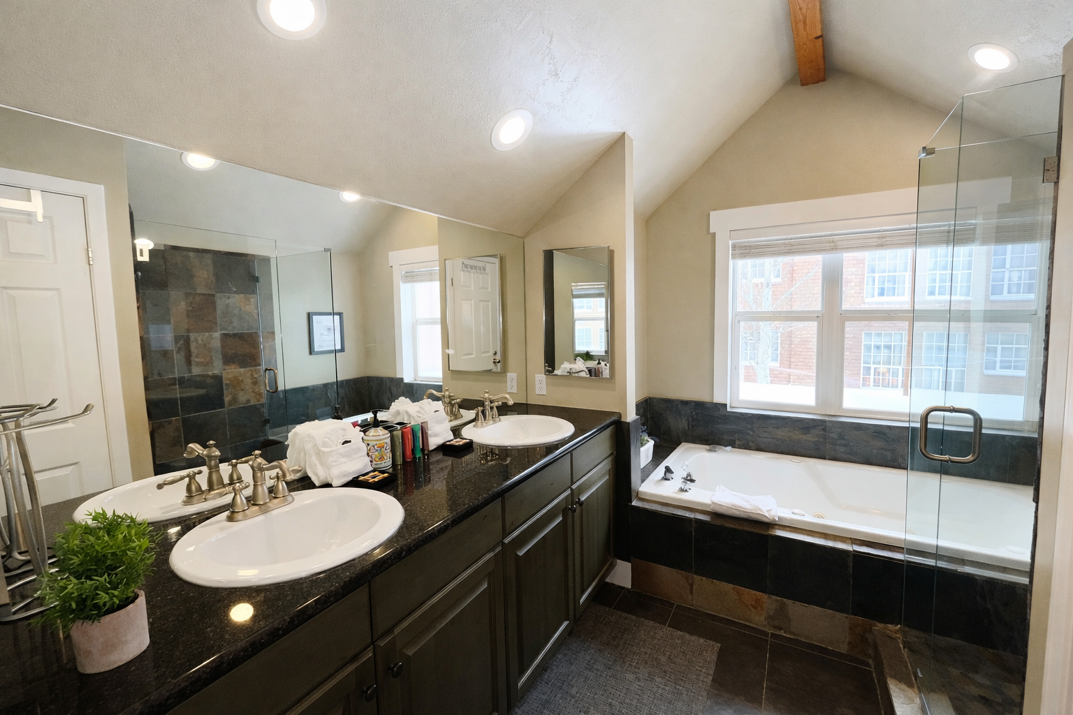 Indulge in the spa-like master bathroom, featuring a double vanity with dark granite countertops and a large jetted soaking tub. It's the perfect place to recharge after a day of adventure.