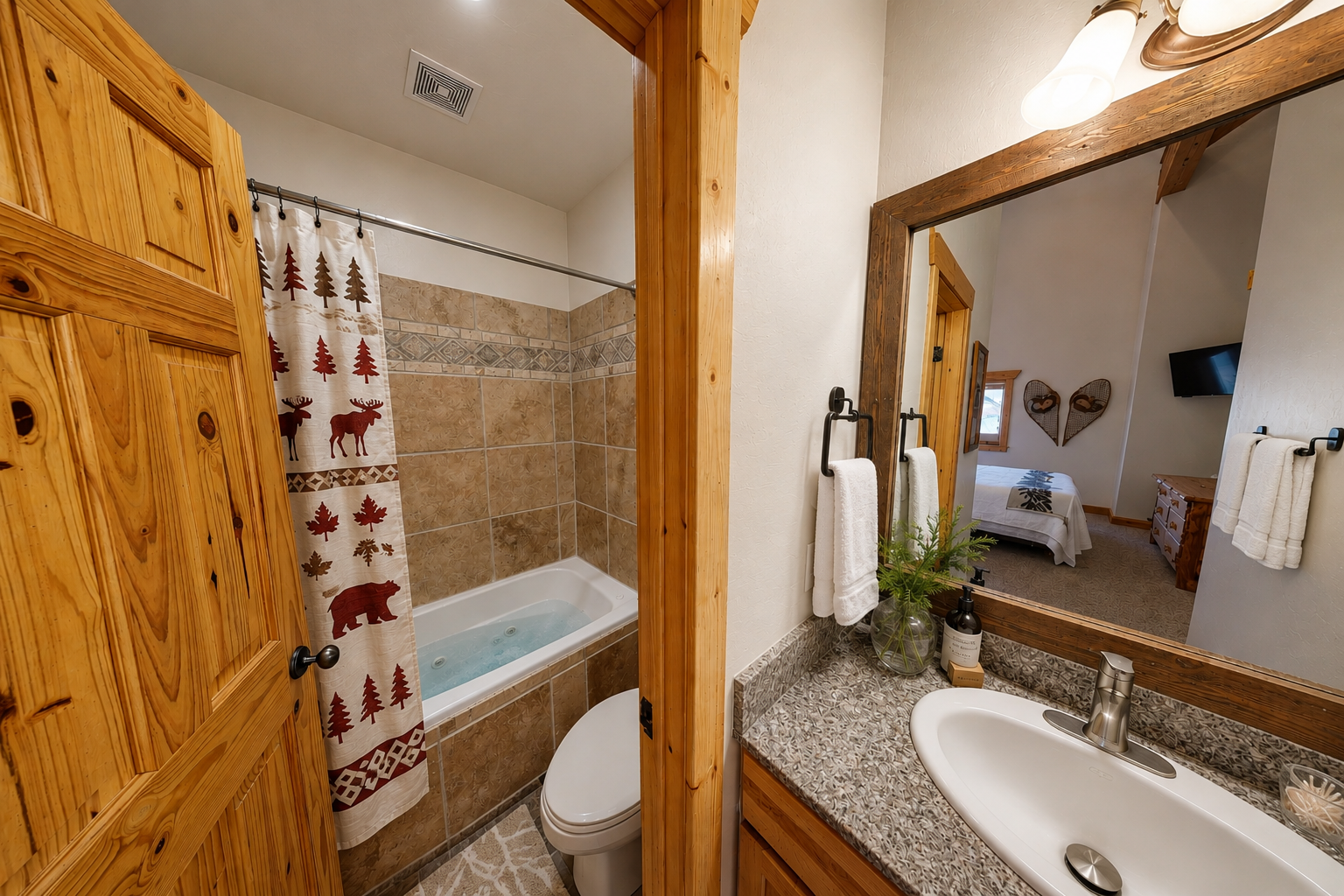 Your private bathroom features warm wood accents, a relaxing tub-shower combo, and rustic mountain-inspired touches that make freshening up feel cozy.