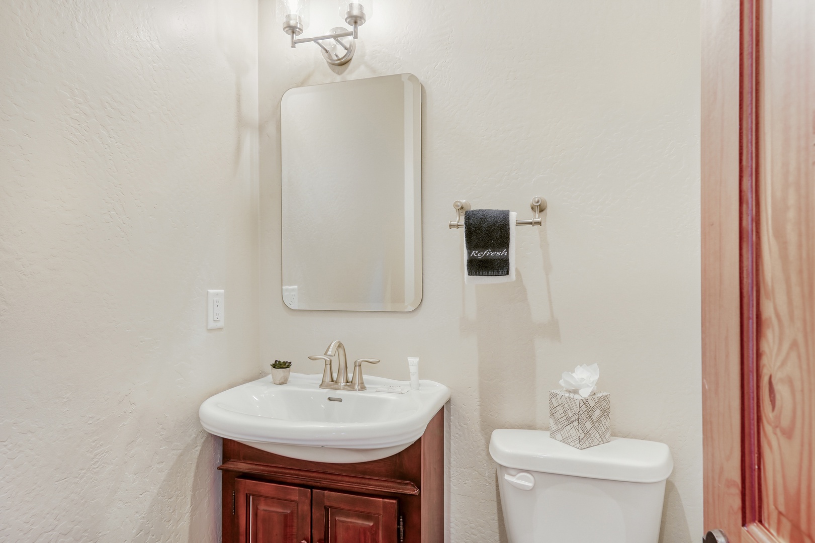 Step into your pristine powder room with gleaming fixtures and thoughtful touches that make freshening up a delight.