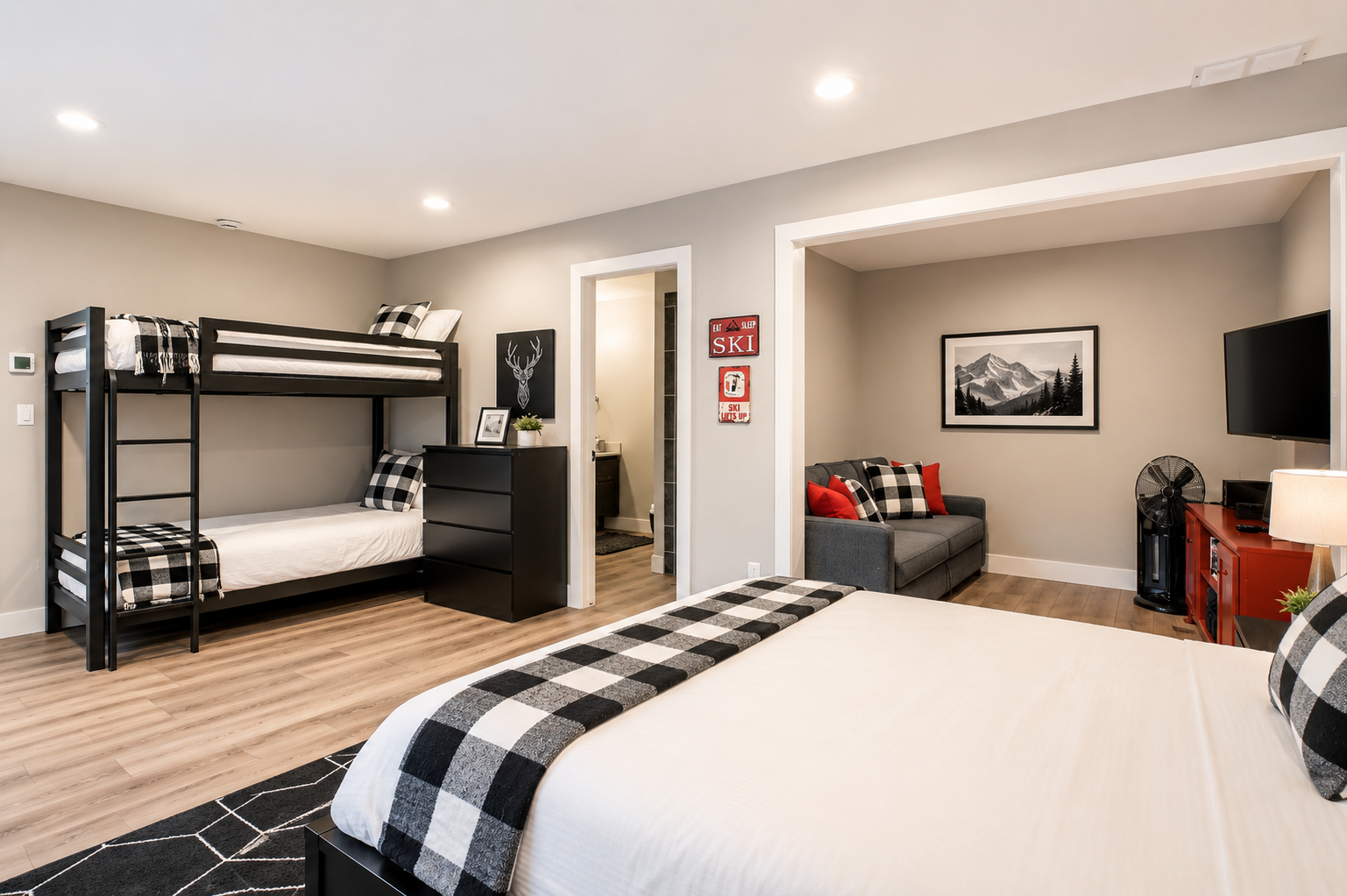Retreat to this cozy bedroom featuring a comfortable queen and twin bunks and TV. The Park City decor creates a perfect mountain getaway.