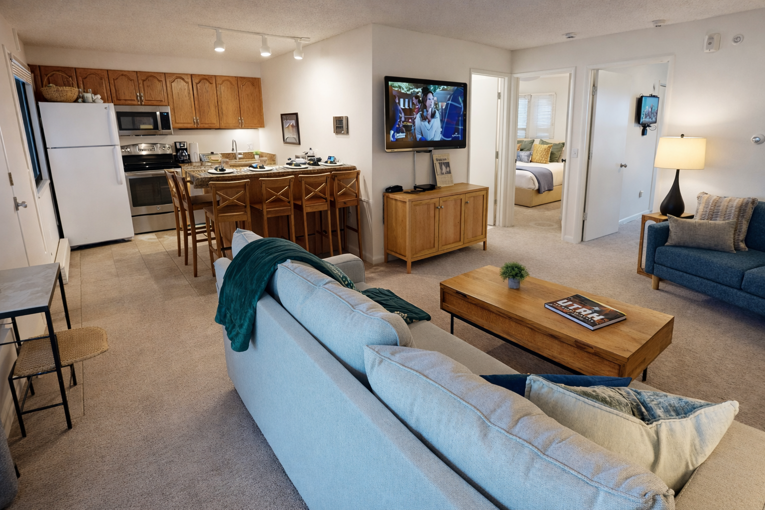 Relax in your spacious living room with plush seating, modern kitchen, and entertainment center—your perfect home away from home awaits.