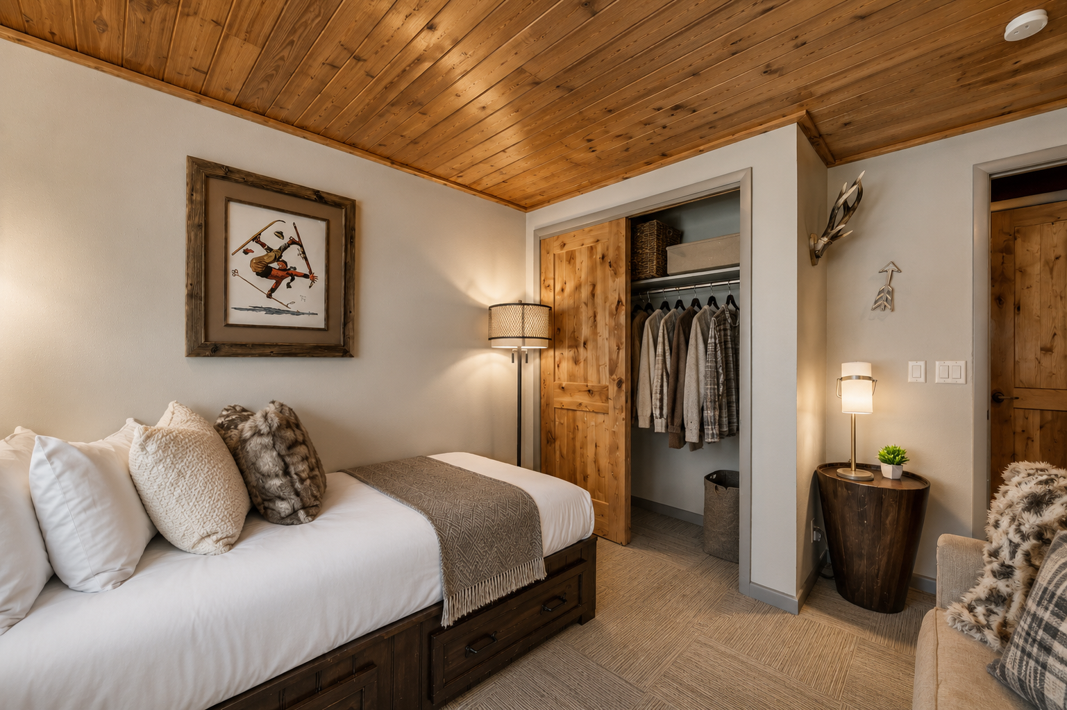 Slip into crisp linens beneath warm wood ceilings, where rustic charm meets mountain elegance. Your personal closet and cozy seating await after a day of adventure.