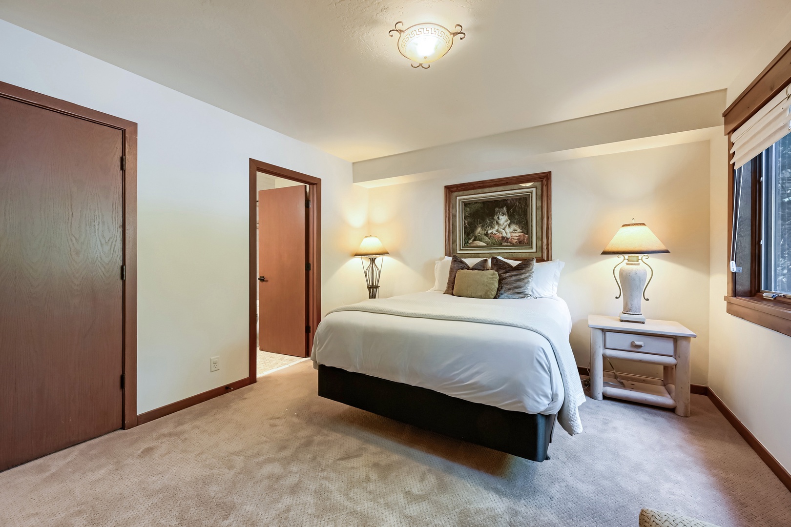 Sink into crisp linens and plush pillows in your peaceful bedroom retreat, where warm lighting and elegant touches create the perfect setting for a restful night's sleep.