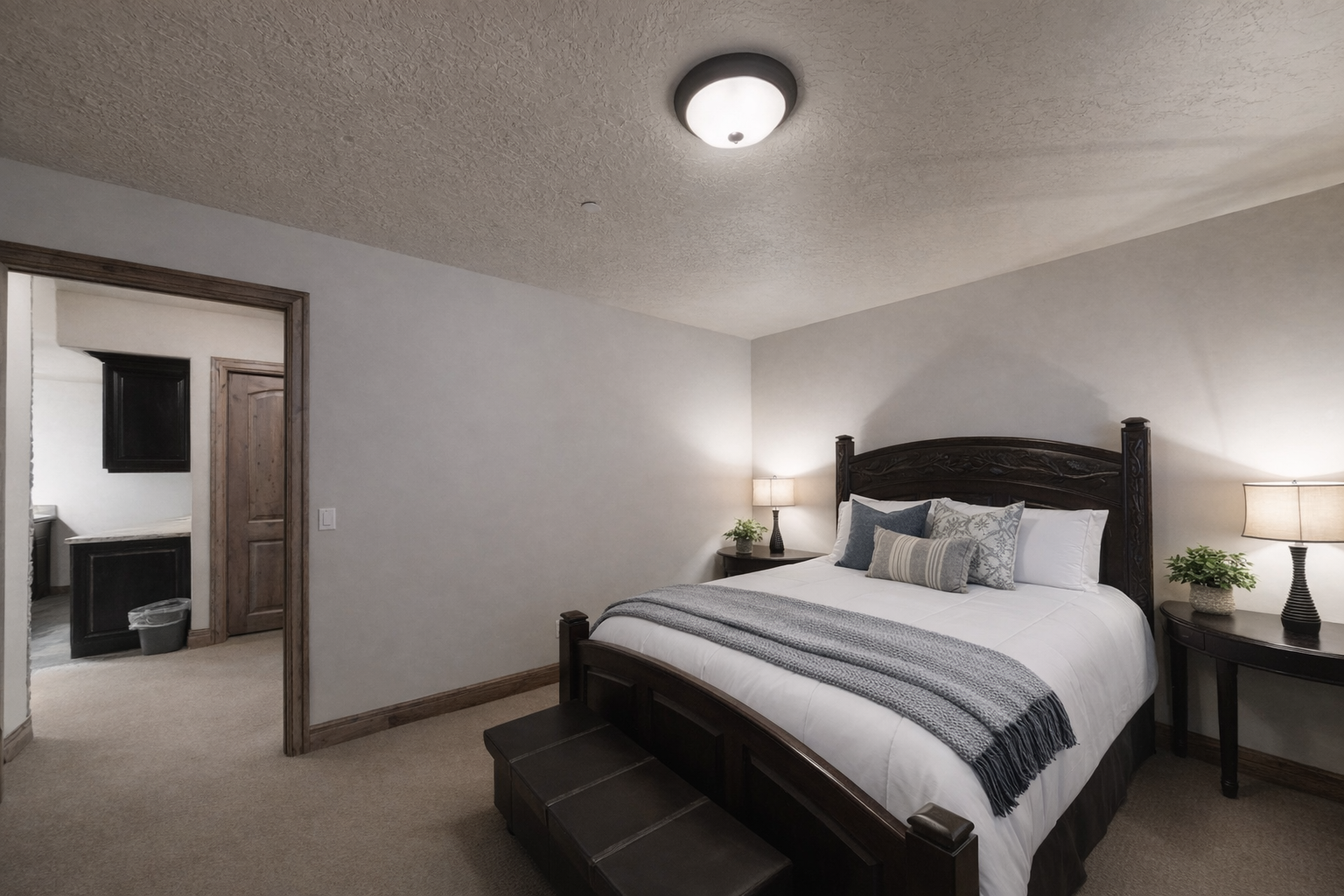 Sink into crisp white linens and soft throw pillows in your elegant bedroom, where warm bedside lighting creates perfect ambiance for restful nights.