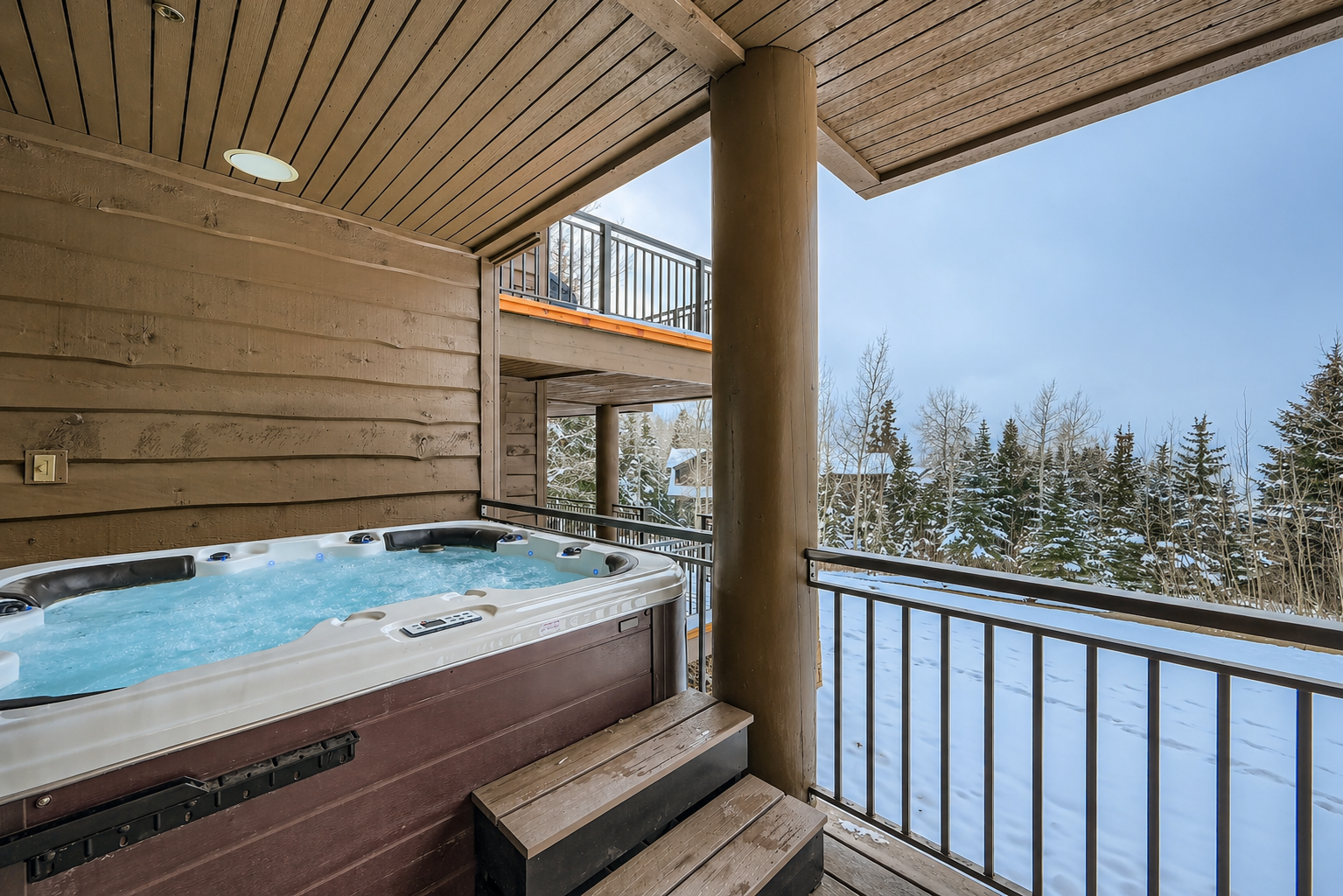 Indulge in a soak after a day on the slopes in your private hot tub with endless mountain views.