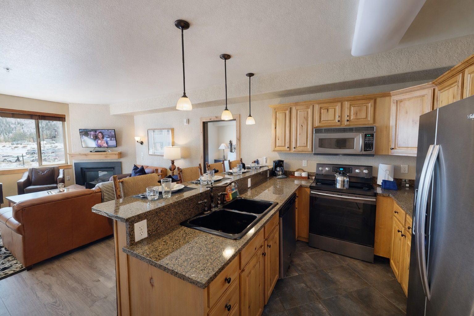 Whip up gourmet meals in this fully equipped kitchen featuring sleek granite countertops, modern stainless steel appliances, and elegant pendant lighting. The open layout makes hosting a breeze!