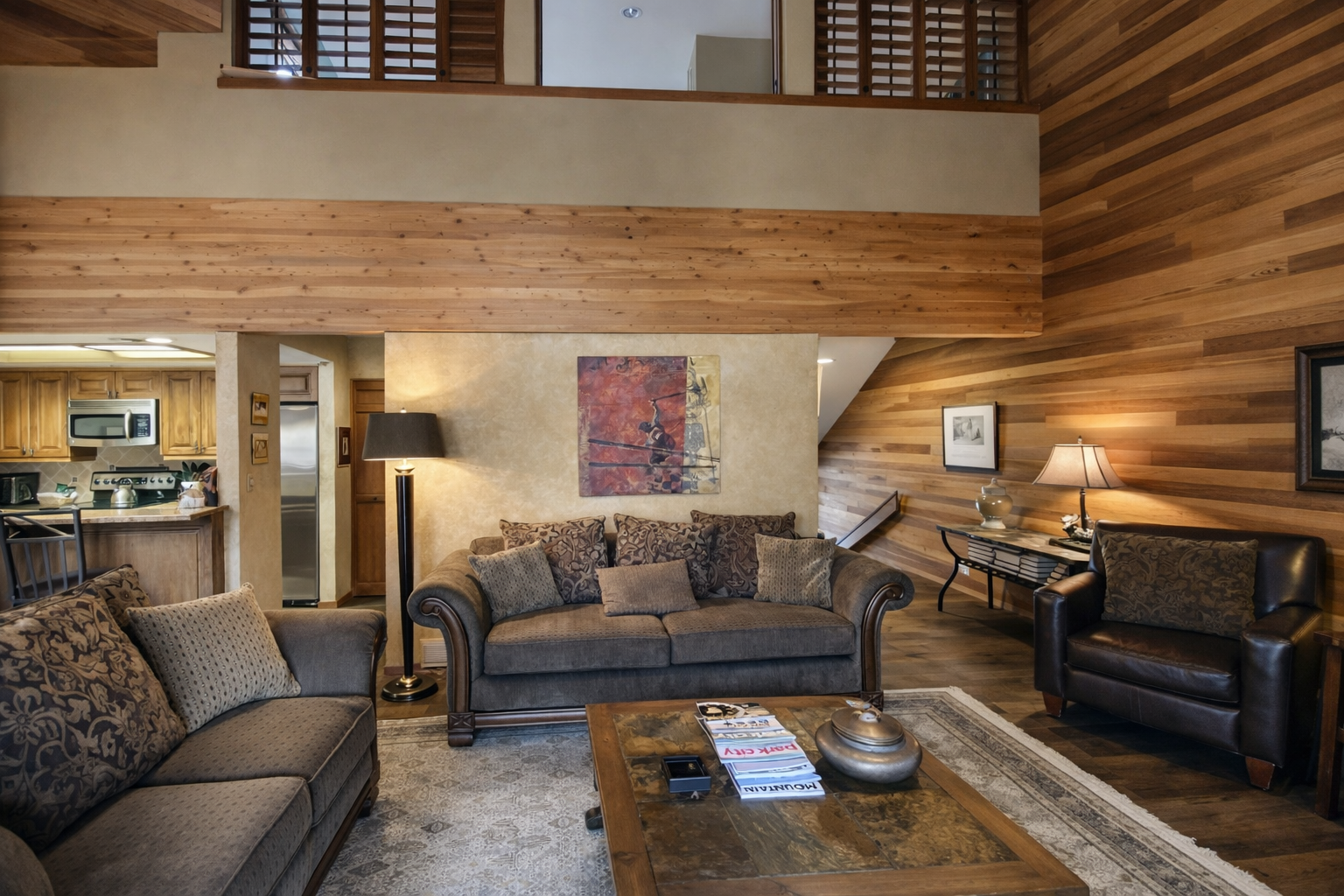 Unwind in your cozy living space with stone fireplace warmth and mountain views through sliding doors.