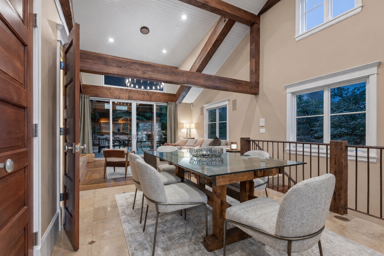 Your elegant dining space features soaring vaulted ceilings with exposed beams, creating an airy yet intimate atmosphere for memorable meals.