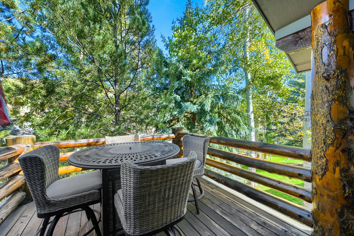 Step out onto this charming deck where towering trees and fresh air greet you. Enjoy your morning coffee or evening glass of wine at your private table, surrounded by rustling leaves and peaceful garden views.