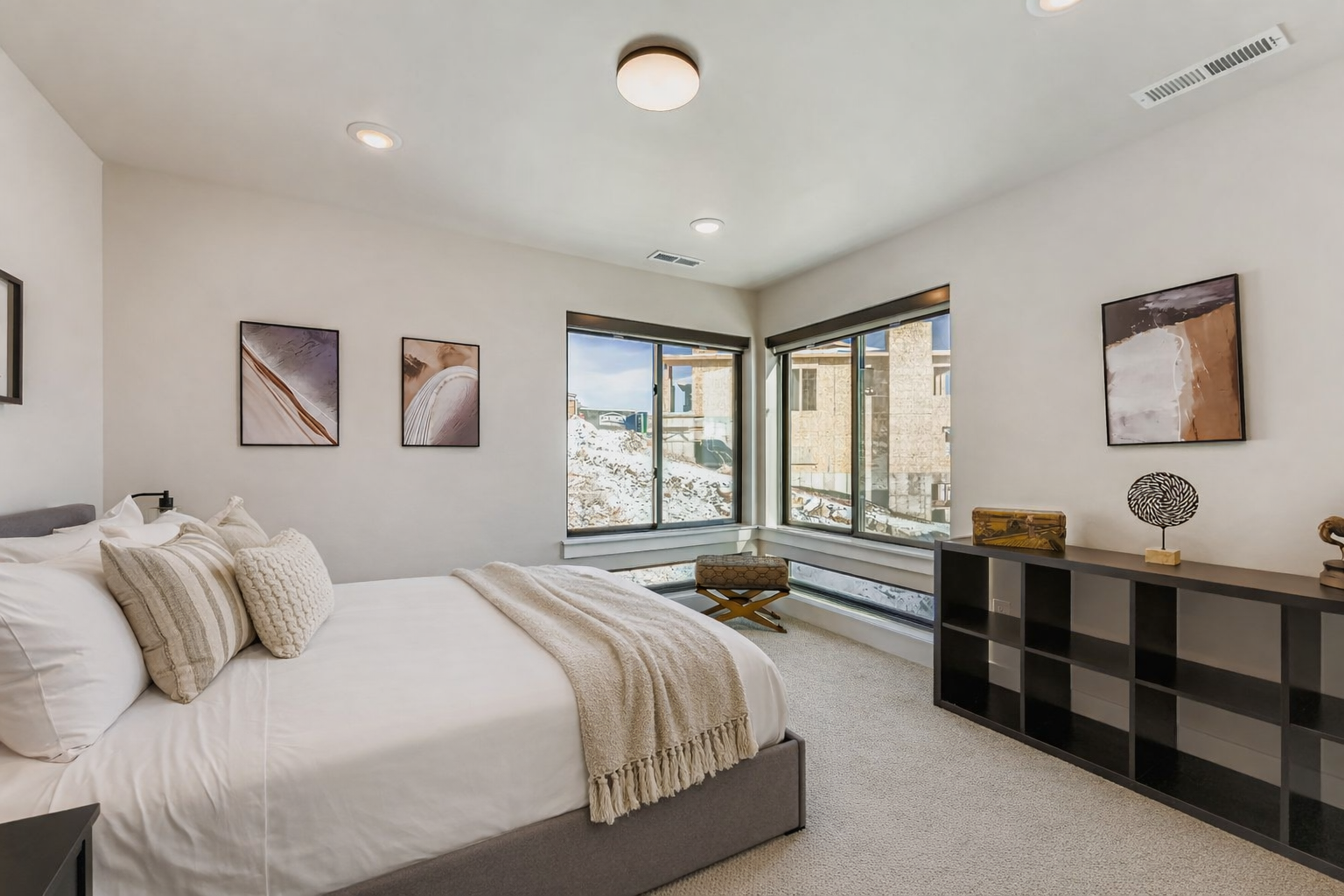 Rest peacefully in your modern bedroom with crisp linens, contemporary artwork, and large windows that fill the space with natural light.