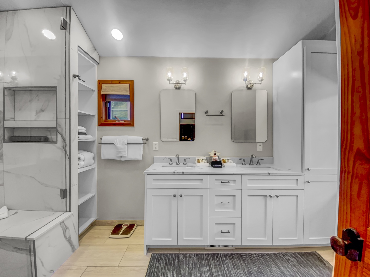 Refresh in this spacious bathroom with dual vanities, marble counters, and plush towels waiting for your arrival.