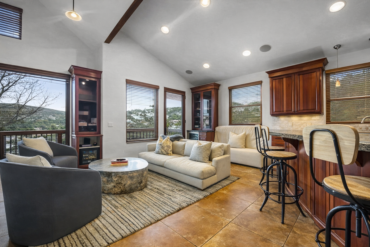 Relax in your open-concept living space with panoramic mountain views, gourmet kitchen, and cozy seating perfect for morning coffee or evening wine.