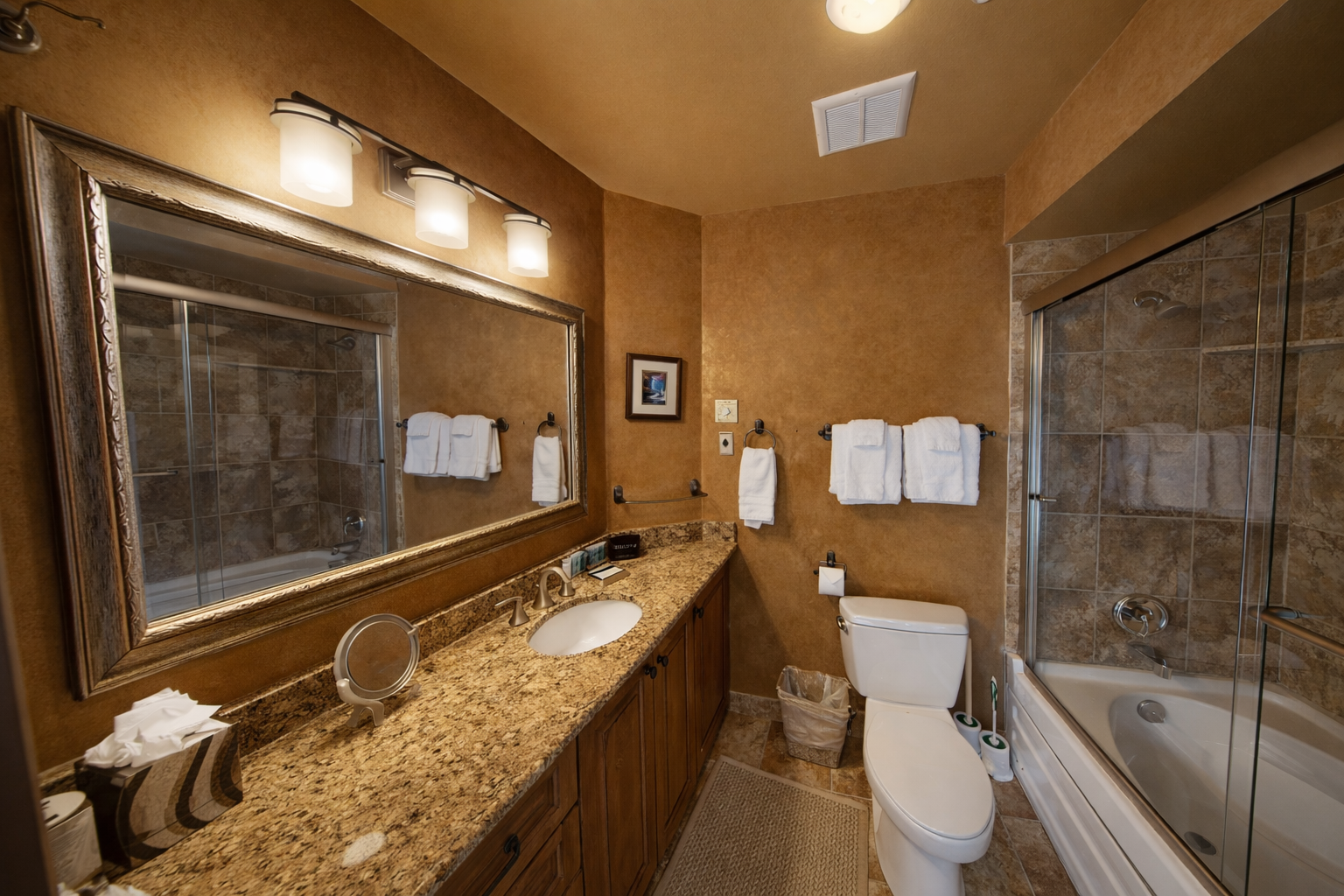 Enjoy our spacious and well-appointed private bathroom. Features include a large granite vanity, full tub/shower combo, and plush towels for a relaxing stay.