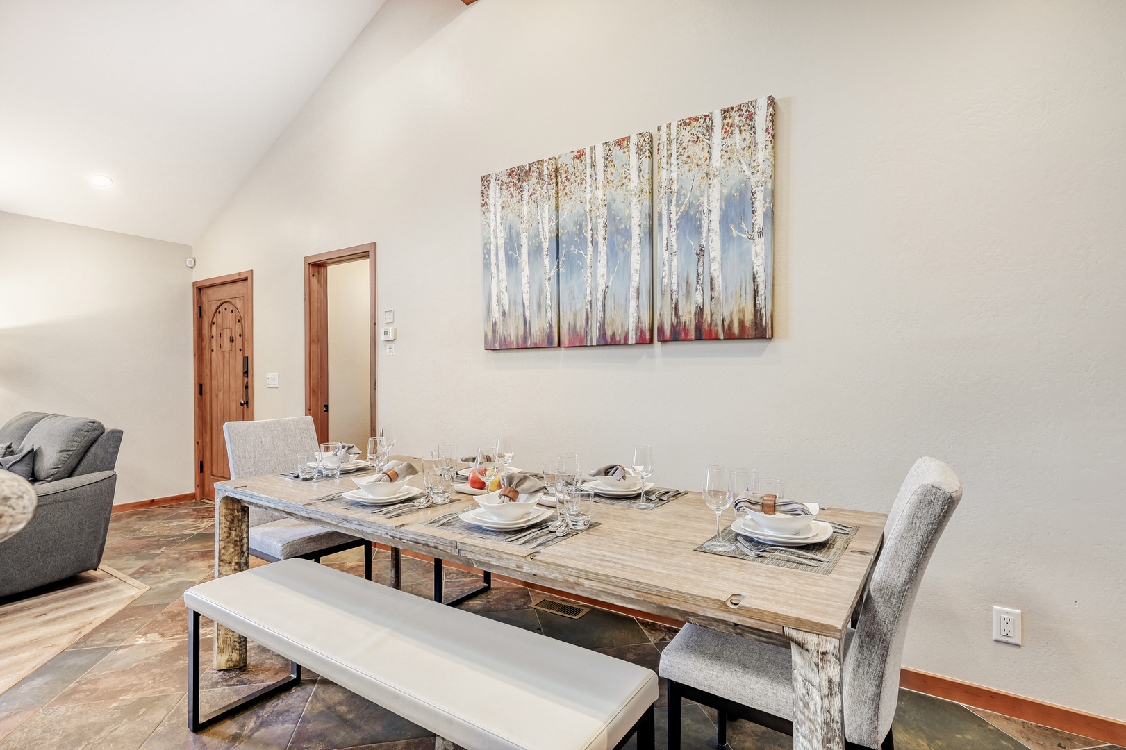 Share memorable meals at your spacious dining table, where rustic wood meets modern style under soaring ceilings.