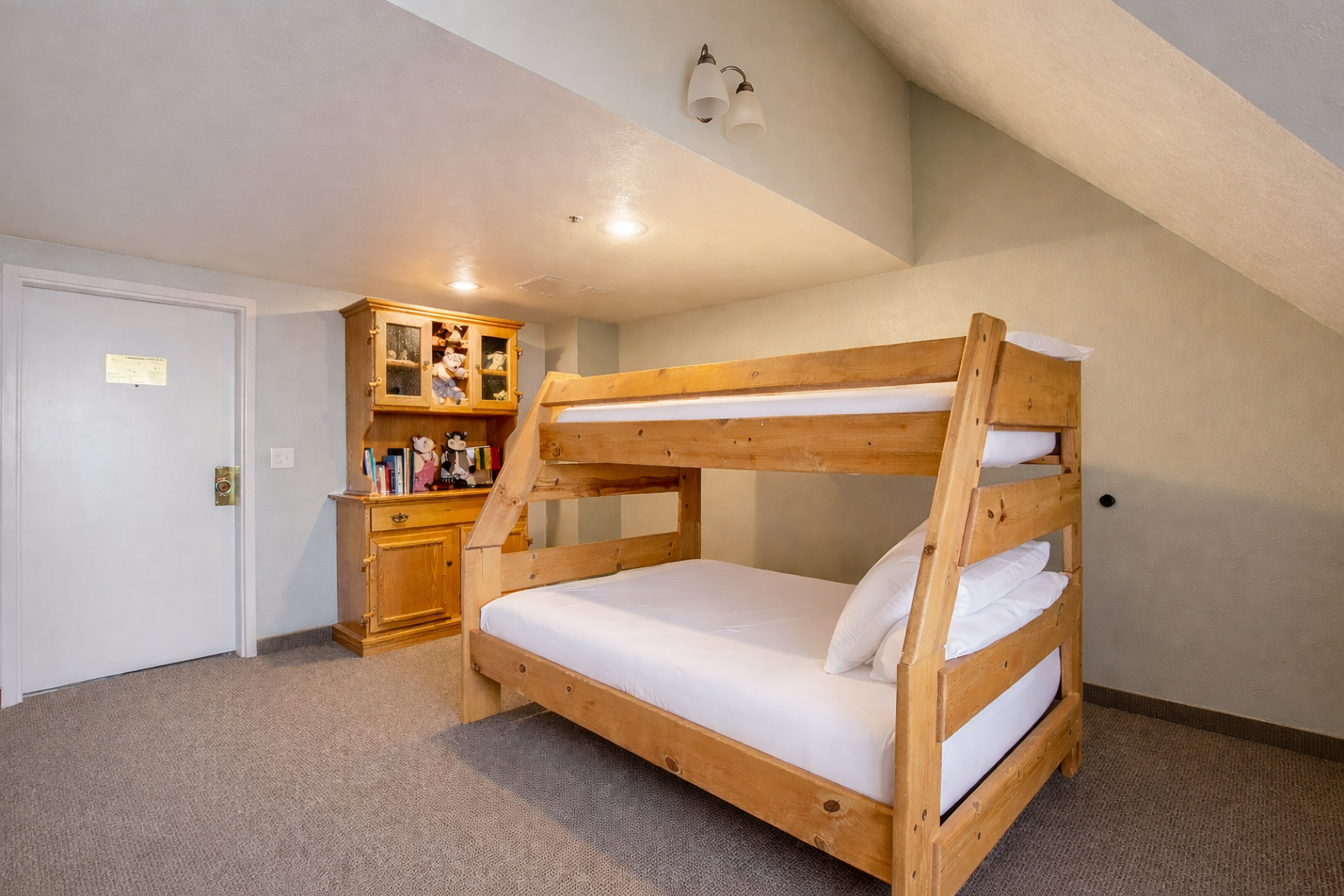 Shared bedroom featuring a comfortable bunk bed (twin over full) and storage hutch. A fun space for the kids to rest after the slopes.