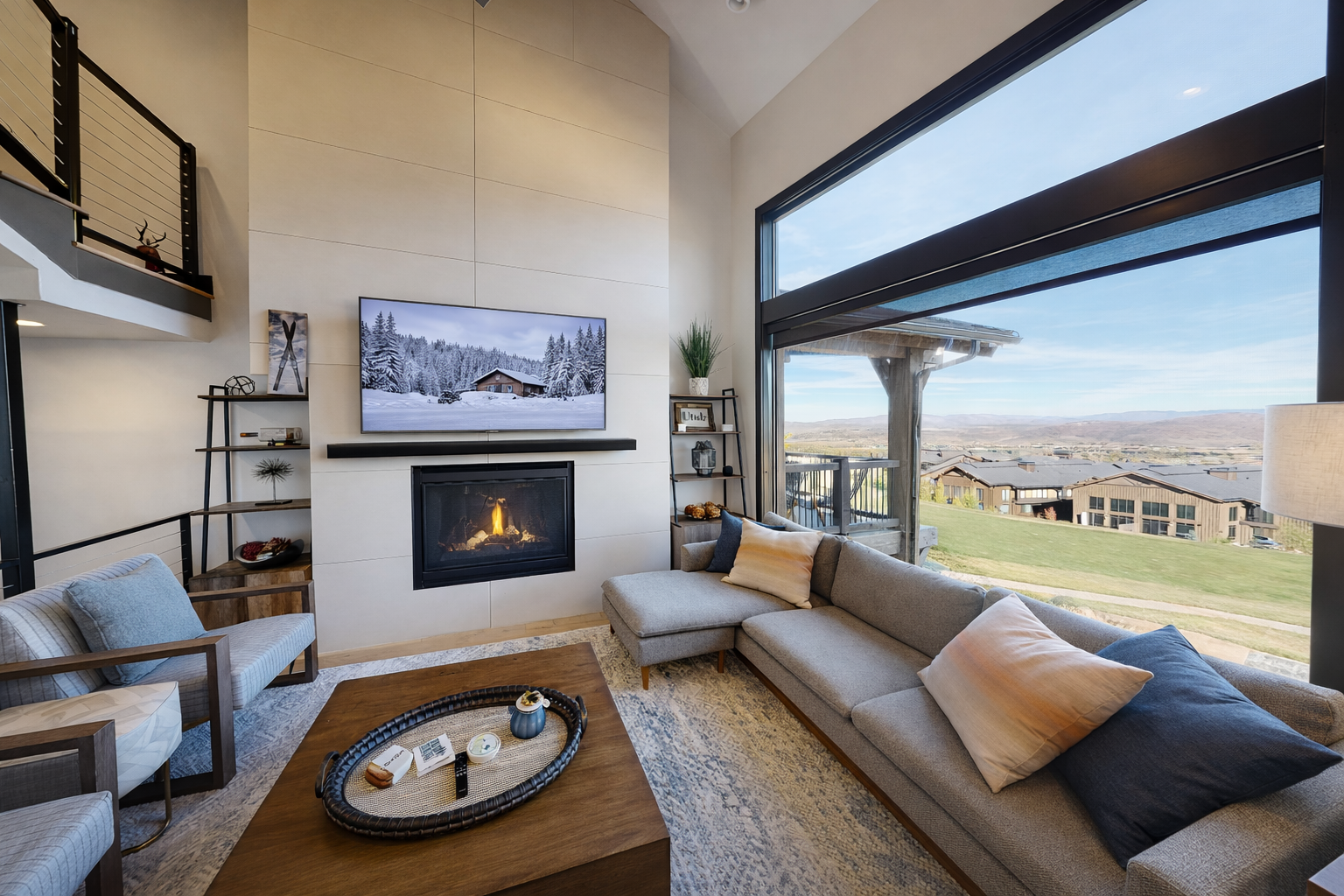 Cozy up by the fireplace in your stylish living room with stunning mountain views and modern comfort.