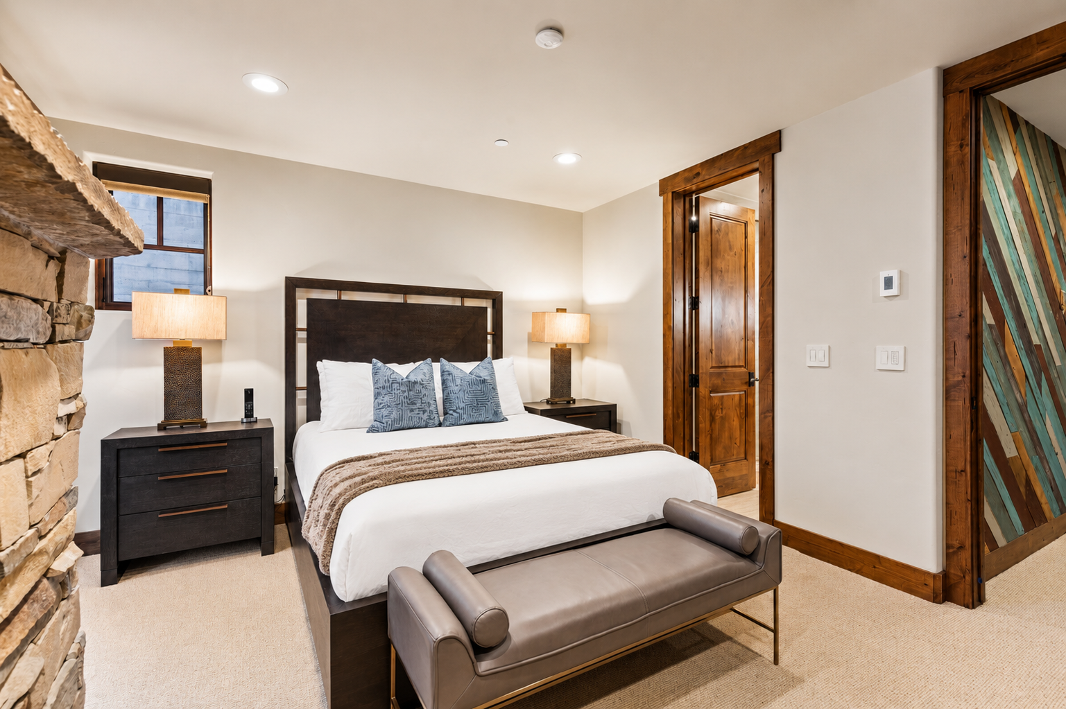 Retreat to the cozy downstairs queen suite with a plush queen-size bed, stylish decor, and a convenient ensuite bathroom.