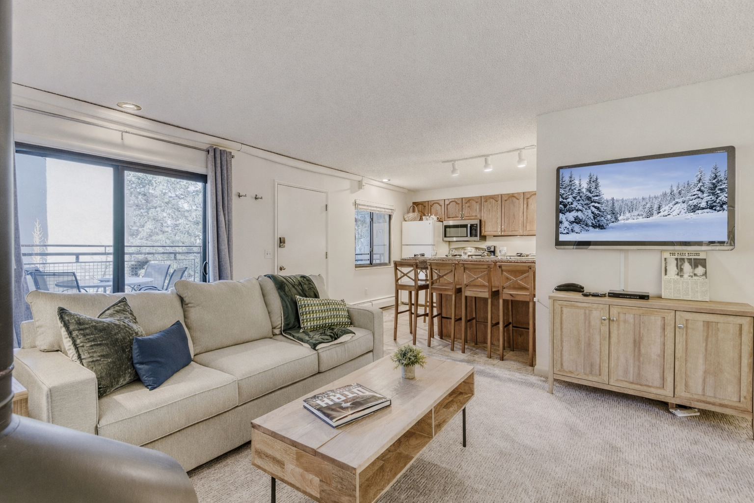 Settle into your cozy living space with plush seating and mountain views, where rustic charm meets modern comfort for your perfect retreat.