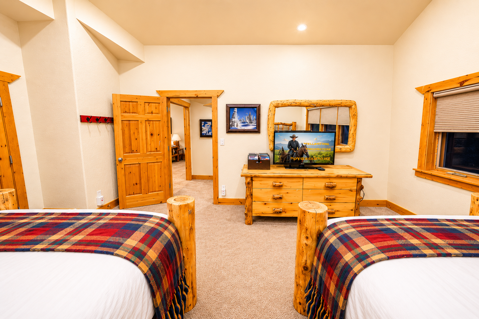 Unwind in your spacious twin bedroom featuring handcrafted log furnishings, a flat-screen TV, and cozy plaid accents for a rustic mountain retreat experience.