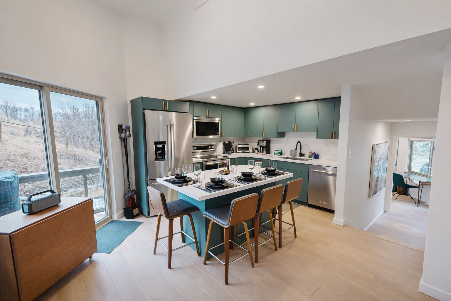 Your modern kitchen features sleek green cabinets, stainless steel appliances, and a spacious island where you can gather for meals and conversation.