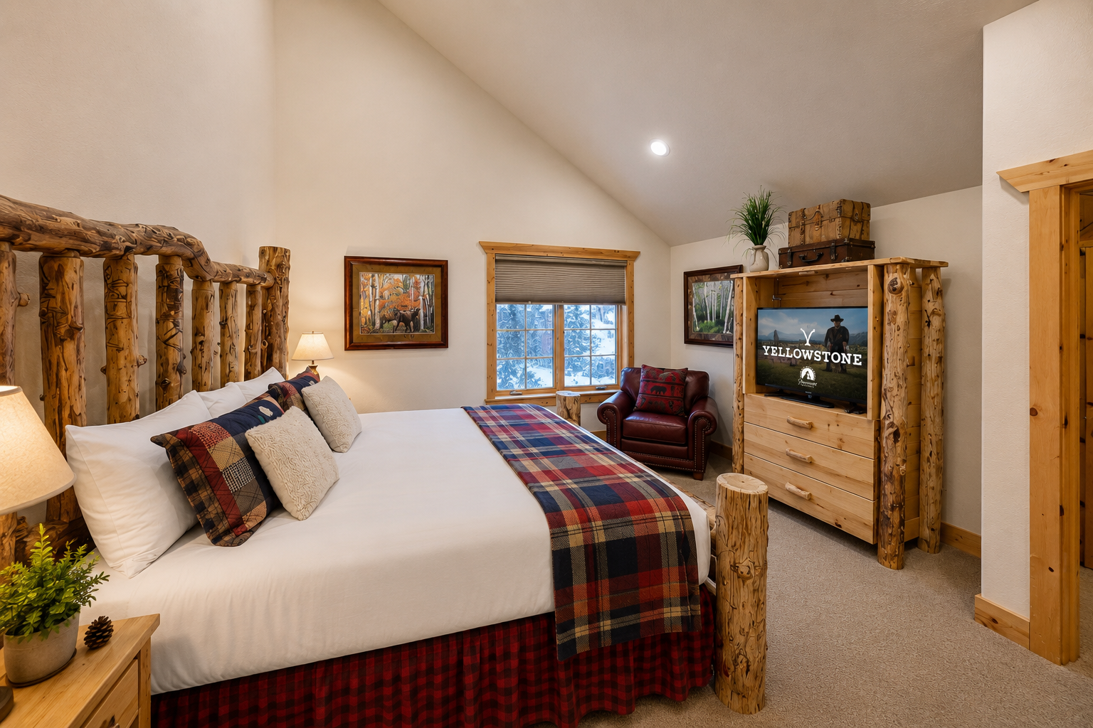Sink into your plush king bed with rustic log accents and cozy plaid bedding. Warm lighting, a leather reading chair, and mountain views create your perfect retreat.