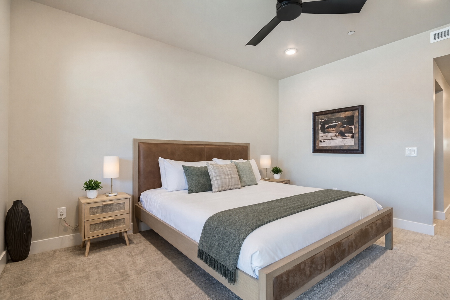 Sink into this serene bedroom where crisp linens and soothing earth tones create your perfect retreat after exploring.