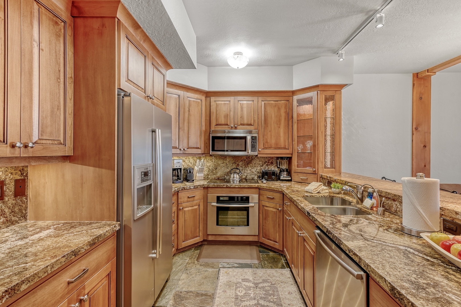 You'll love preparing meals in this stunning gourmet kitchen, featuring granite counters, and premium appliances.