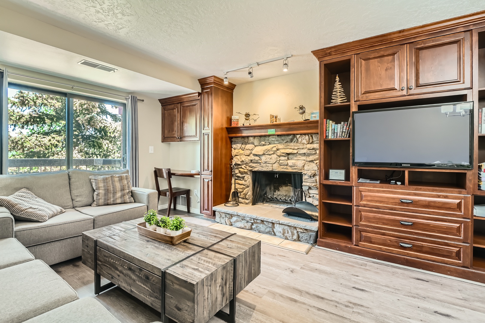 Settle into your inviting living space, where a stone fireplace and plush seating create the perfect spot to unwind after exploring the area.