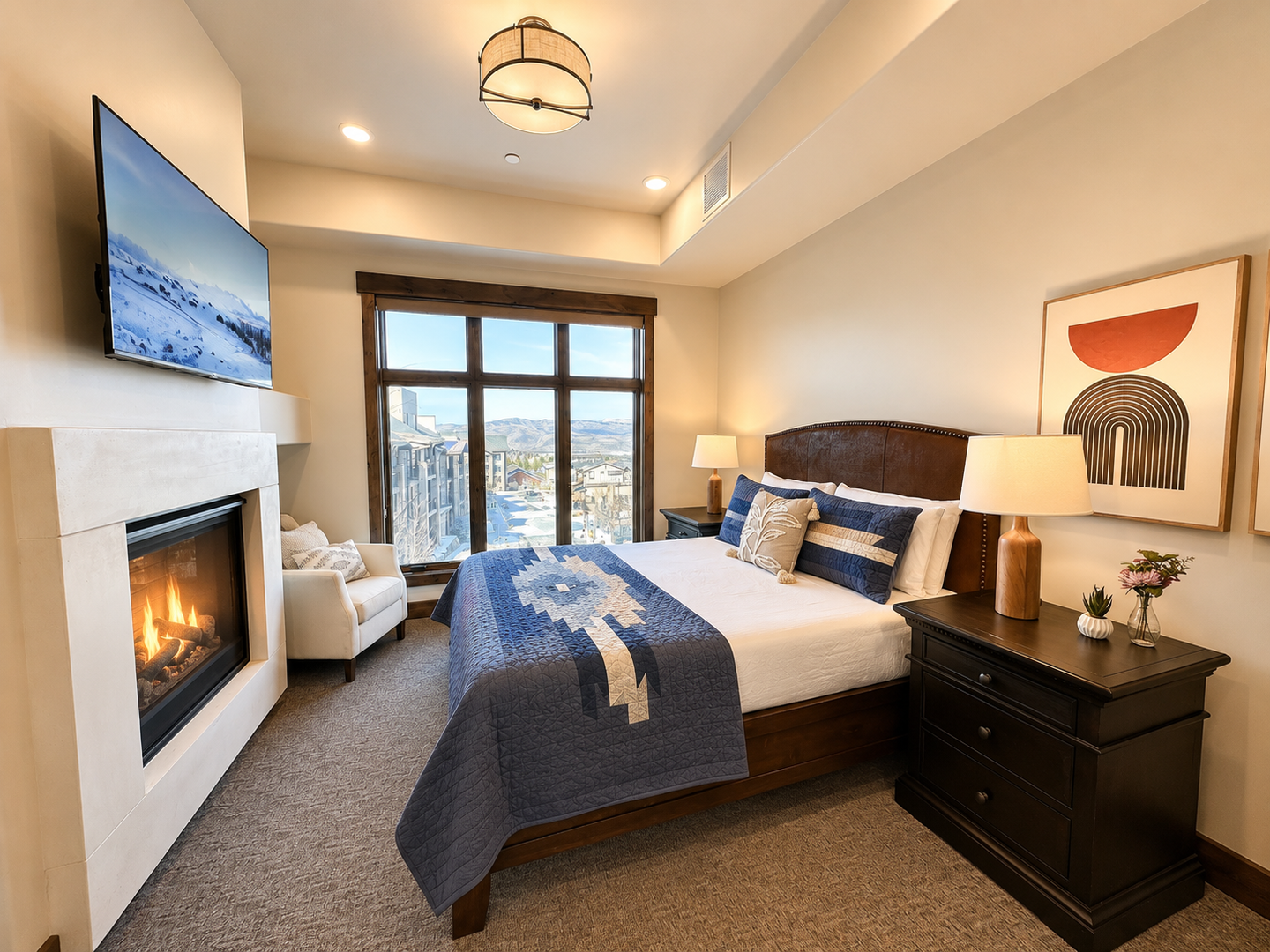 Unwind in your beautifully appointed bedroom with a cozy fireplace, plush bedding, and mountain views. The warm ambiance and thoughtful details create your perfect retreat after a day of adventure.
