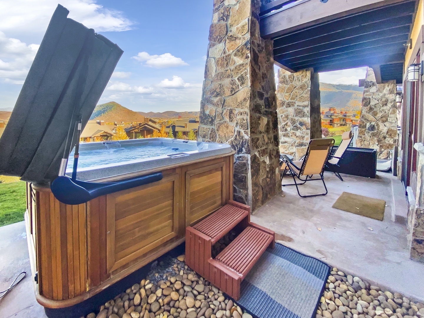 Step outside to your private covered patio, where a hot tub awaits beneath mountain vistas and endless skies—your peaceful retreat after a day exploring the area.