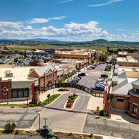 An aerial view reveals this vacation rental property and its surrounding neighborhood, with open landscapes and mountains framing the horizon.