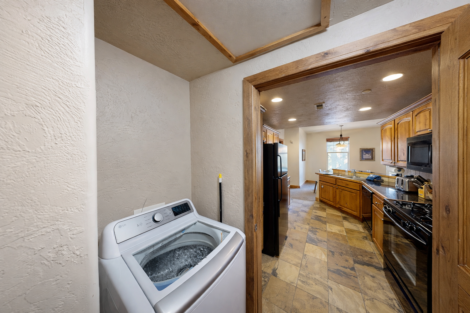 Convenient laundry area with a full-size LG washer and dryer, located near the kitchen and living spaces.