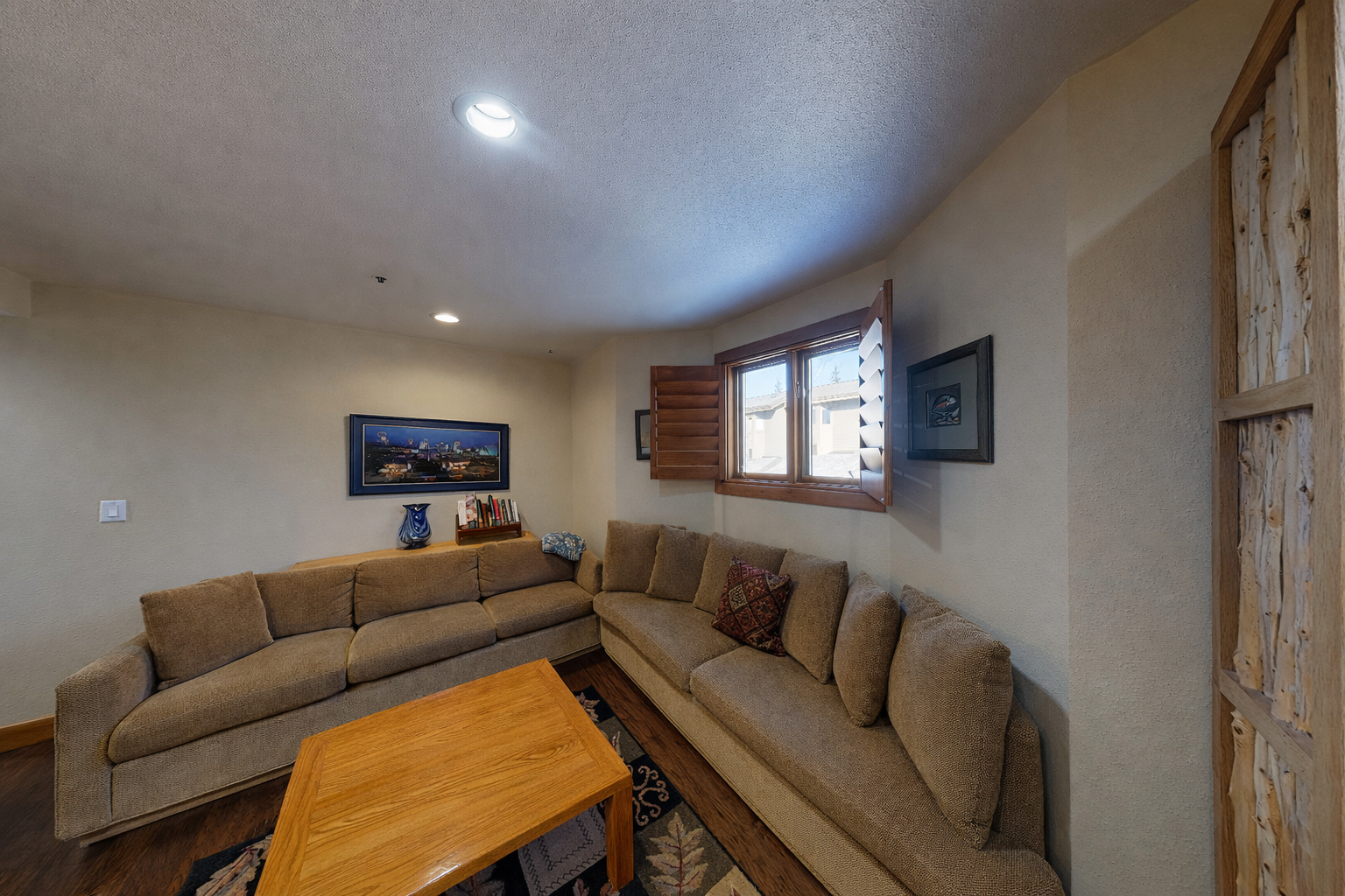 Enjoy the cozy living room's plush sectional and rustic wooden coffee table, perfect for relaxing after a day of exploring Park City.