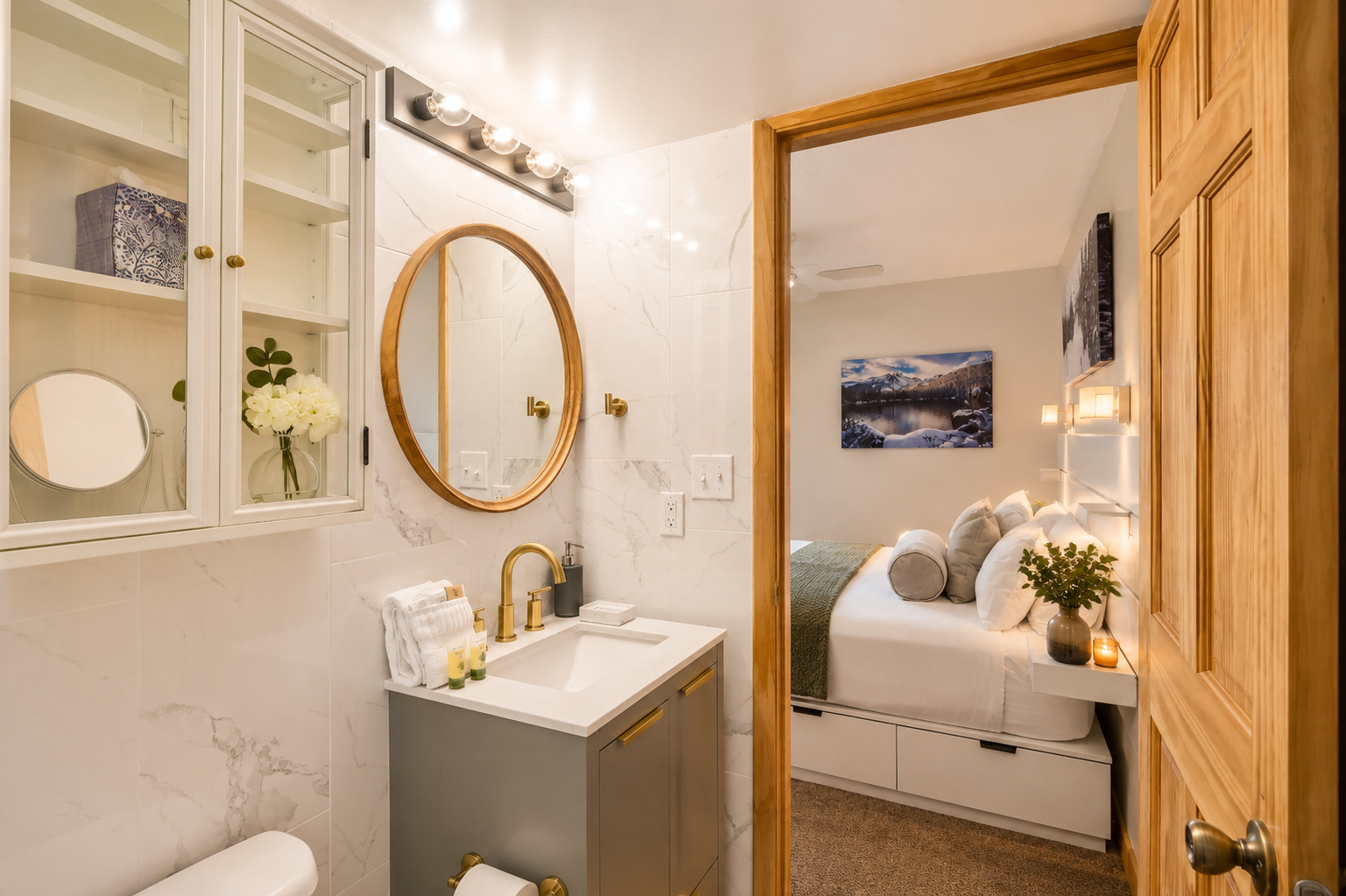 Your private ensuite bathroom sparkles with marble accents, elegant gold fixtures, and soft vanity lighting, perfectly connecting to your tranquil sleeping space just steps away.