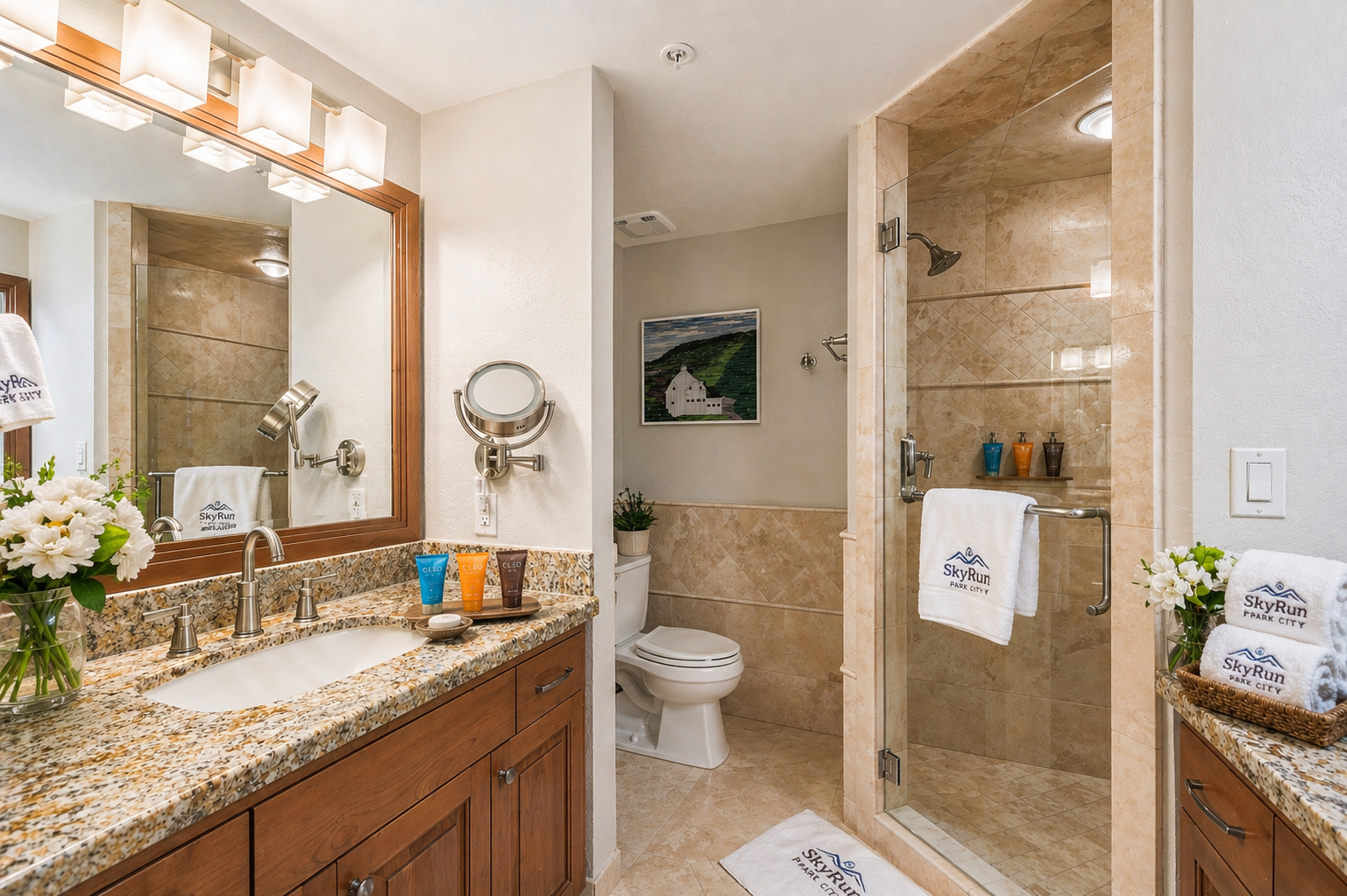 Elegant bathroom featuring granite countertops, warm wood cabinetry, and a spacious glass shower where you can unwind after your day of exploring.