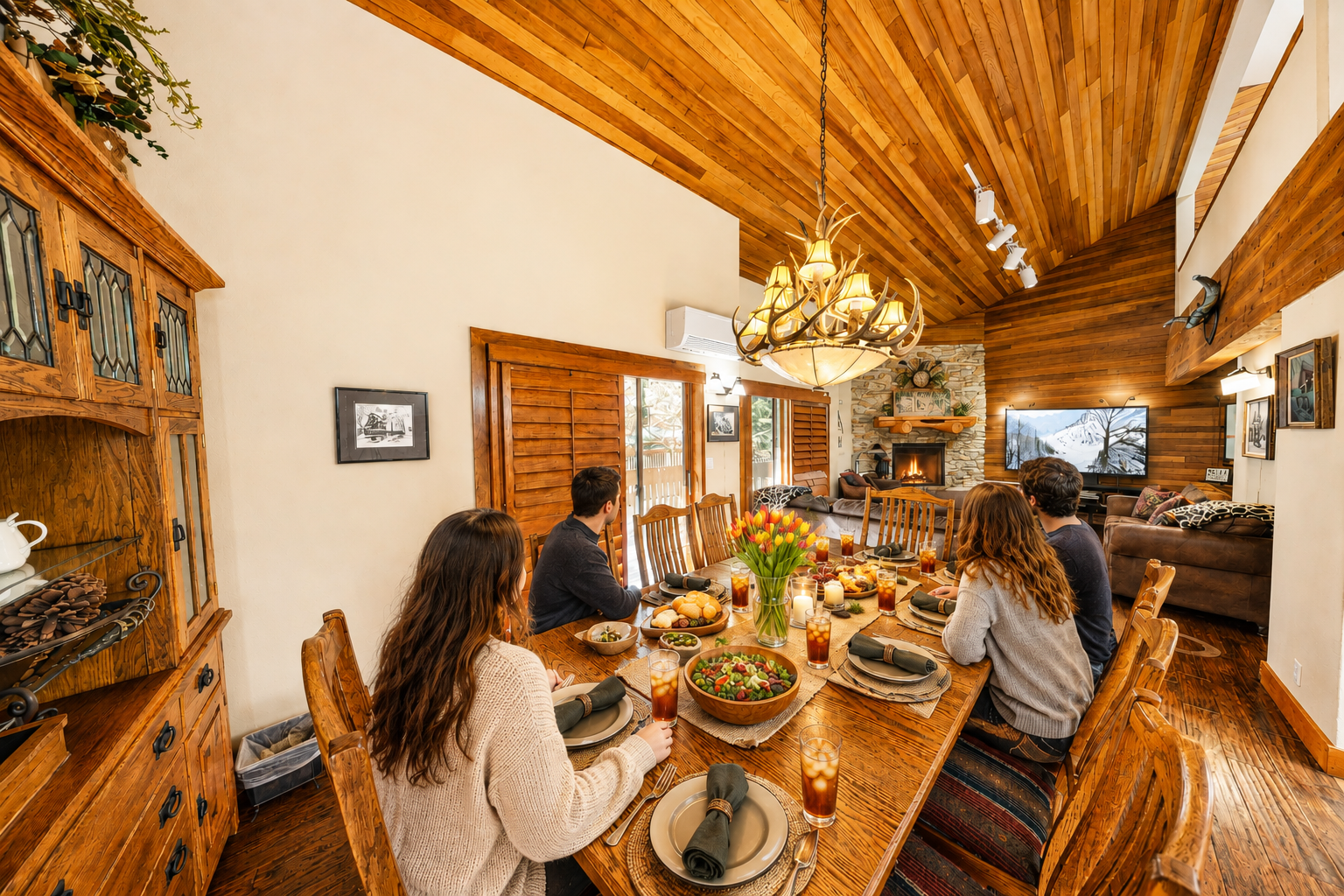 Gather around your spacious dining table beneath warm wood beams and natural light streaming through windows.