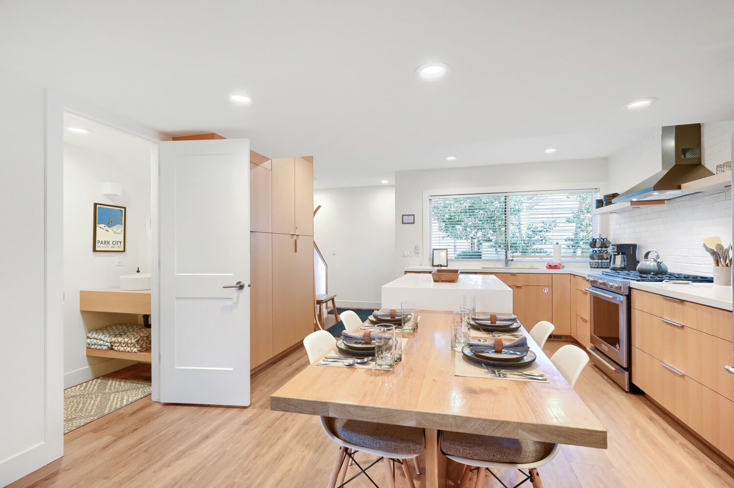This bright, modern kitchen and dining space welcomes you with warm wood tones and plenty of natural light. The open layout invites you to cook, dine, and connect with ease.