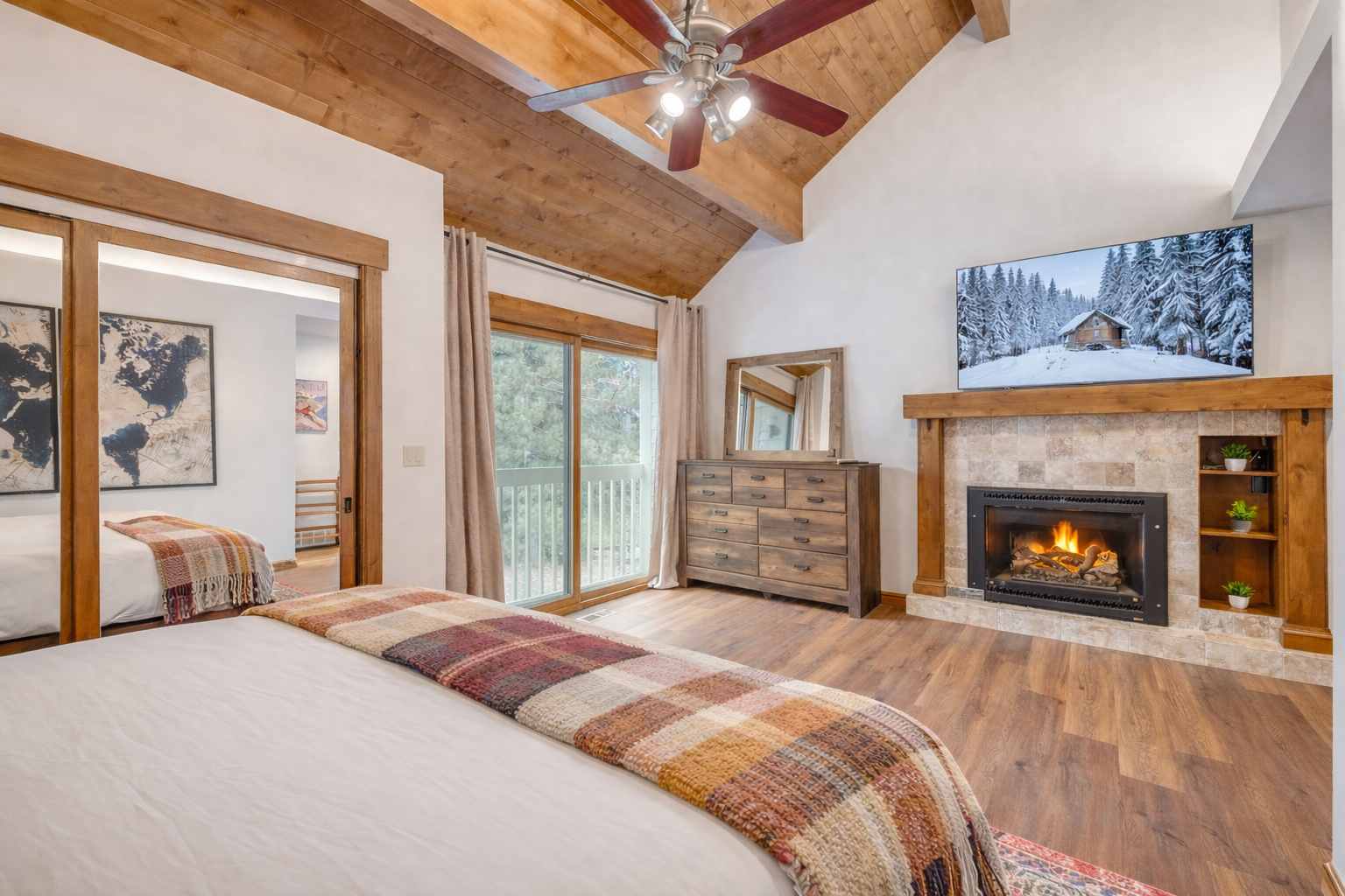 Your cozy bedroom features exposed wooden beams, a crackling fireplace, and mountain views—perfect for romantic evenings after snowy adventures.