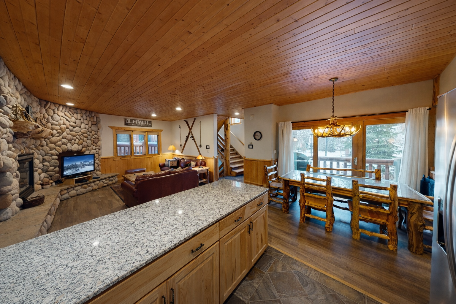 Curl up by the stone fireplace or gather at the dining table under warm wood ceilings—your cozy mountain retreat invites you to unwind and connect.