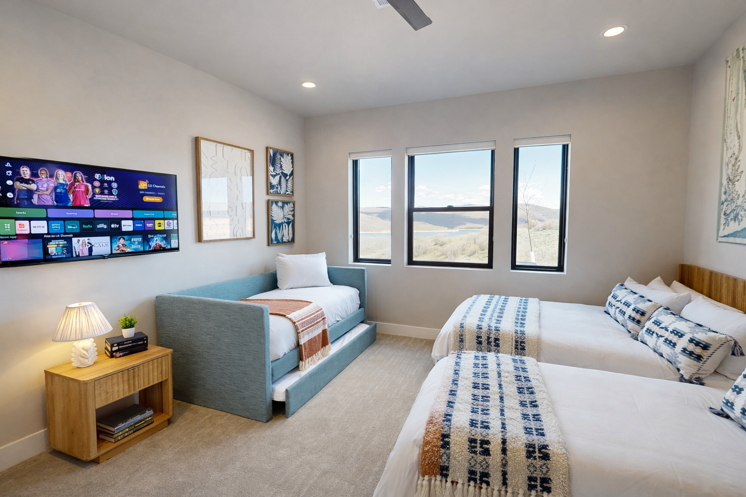 This flexible bedroom features two queen beds and a twin trundle daybed, comfortably sleeping four. Bright windows offer scenic views, while the wall-mounted Smart TV ensures endless bedtime entertainment.