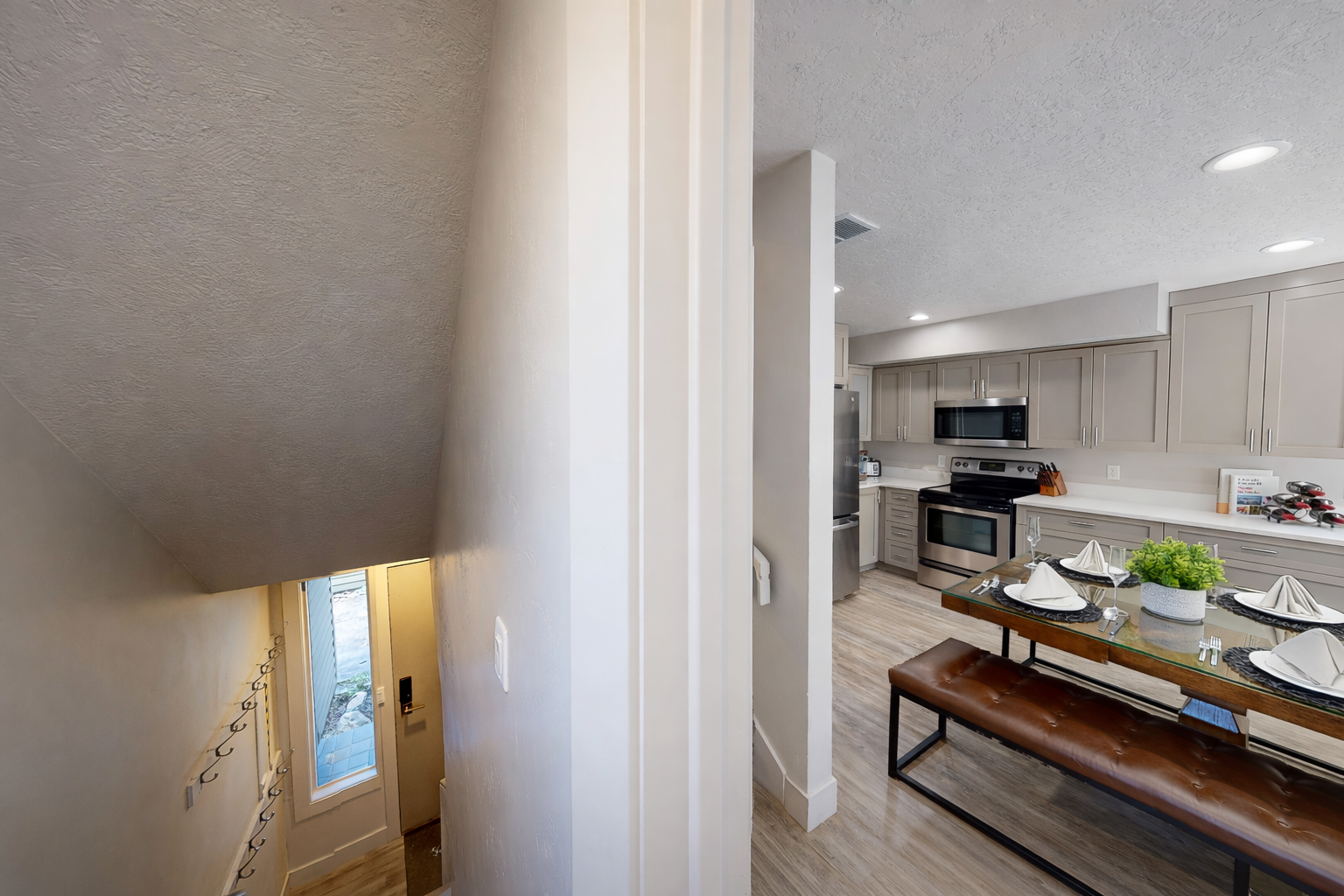 Enjoy a modern open-concept kitchen with contemporary finishes. Features include a gas range, integrated microwave, and ample seating, creating a warm and social atmosphere for your group.