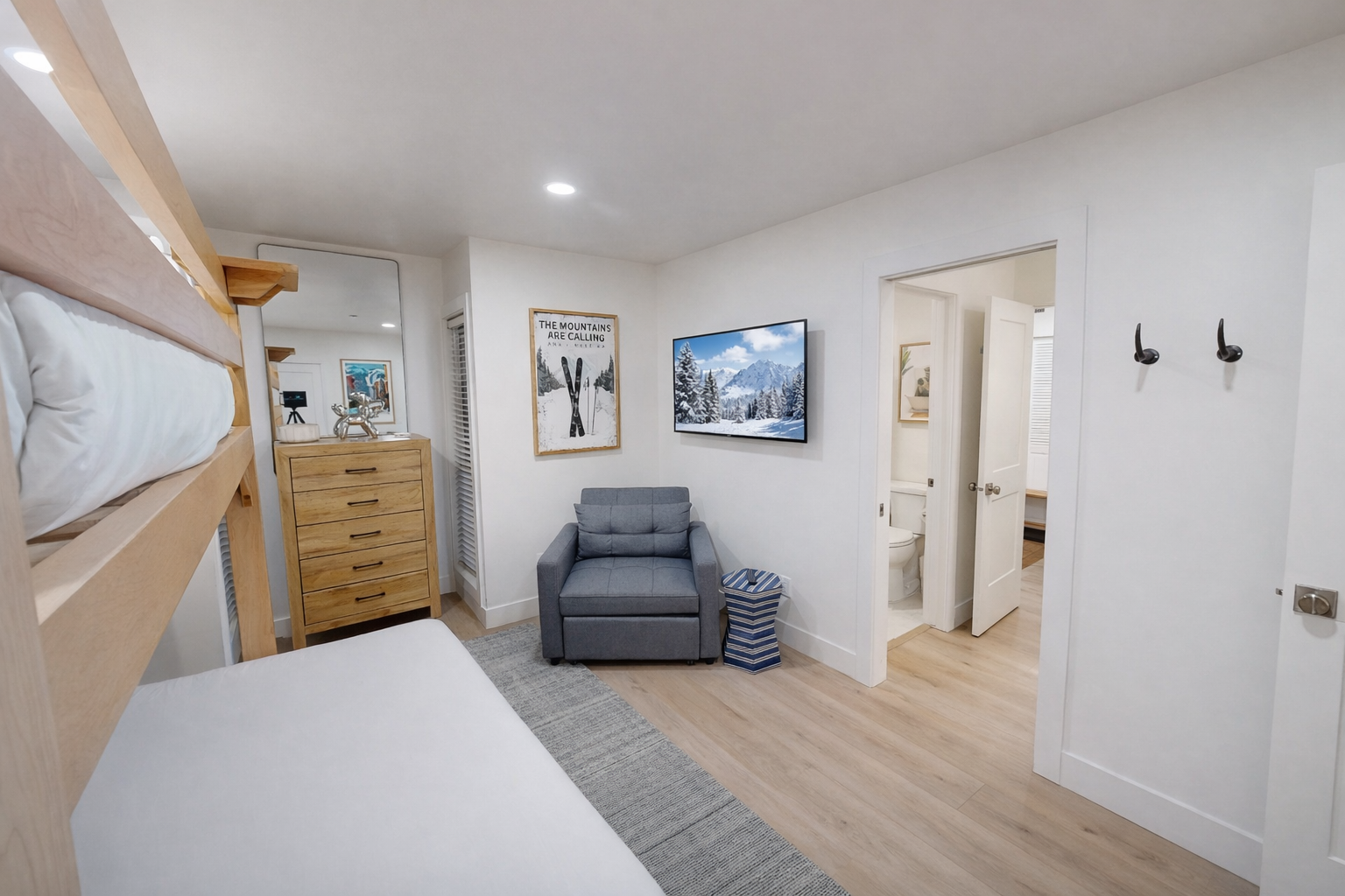 Relax in your bright, modern living space with a large flat-screen TV and comfortable seating, perfect for unwinding after exploring the area.